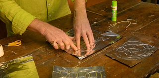 Lincoln Austin demonstrating his Al-foil drawing activity, July 2025 / Photograph R Jones