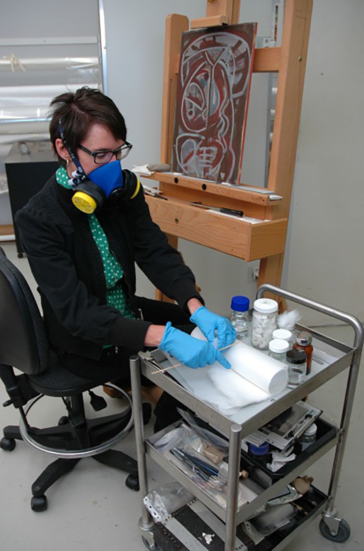 During the varnish removal process, solvents are applied through Japanese tissue to remove the varnish while protecting the paint surface.