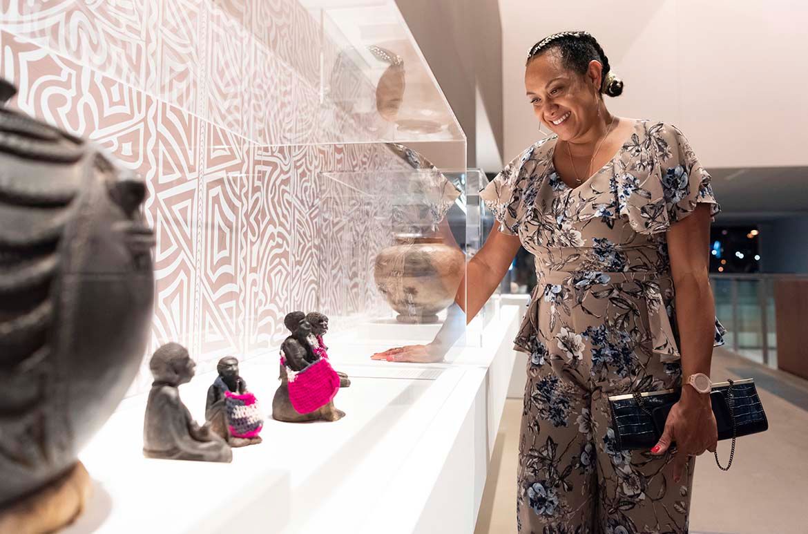 Korina Gole with her mother’s work on display for ‘The 10th Asia Pacific Triennial of Contemporary Art’, GOMA, Brisbane, December 2021 / © Joyce Mary Aresepa Gole, OL / Photograph: M Campbell © QAGOMA