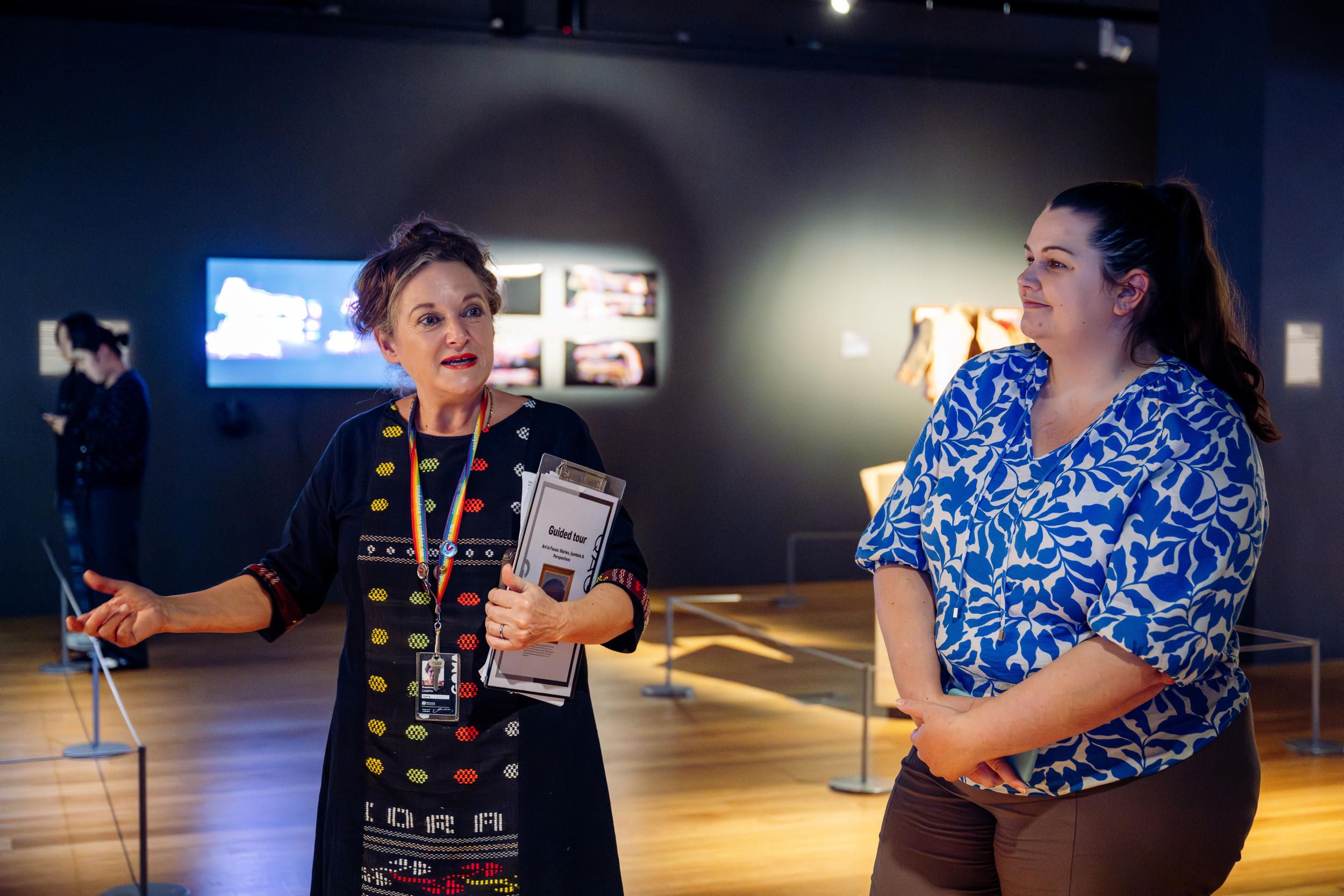 A Volunteer Guide engages visitors on a tour at the Gallery of Modern Art. Photography by Joe Ruckli | QAGOMA