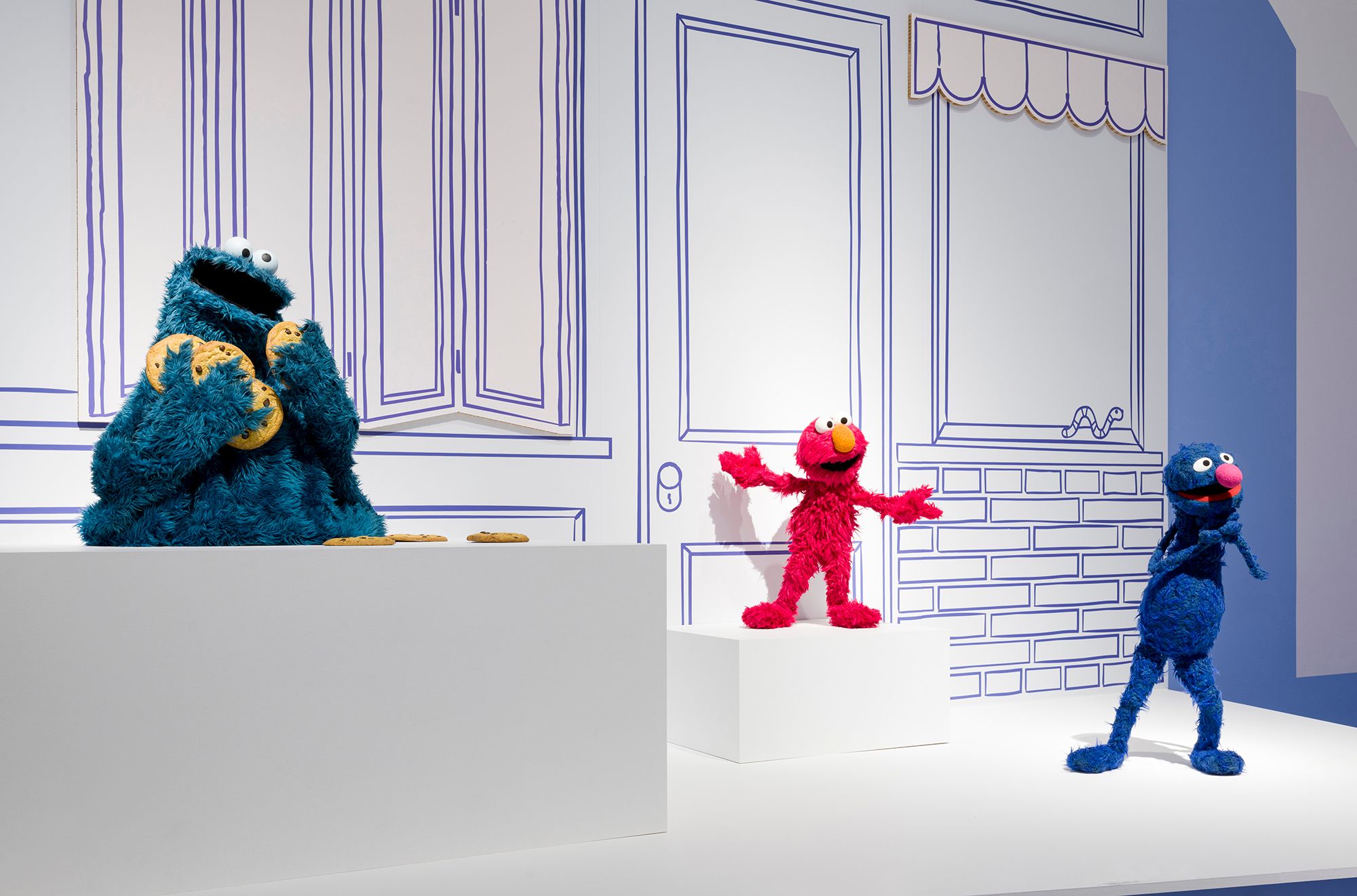 Installation view of 'Make, Believe, Magic: The Worlds of The Jim Henson Company', Gallery of Modern Art (GOMA), Brisbane, 2026, featuring 'Cookie Monster', 'Elmo' and 'Grover' puppets from Sesame Street 1969–present / Collection: Sesame Workshop, New York / © 2026 Sesame Workshop. All Rights Reserved / Photograph: C Callistemon © QAGOMA