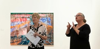 An Auslan interpreter accompanies a volunteer guide on a tour for d/Deaf visitors in GOMA. Installation view features The Bowl 2018 by Jon Cattapan, Australia b. 1956 © Courtesy the Artist and Milani Gallery, Brisbane

Photograph by C. Baxter | QAGOMA

