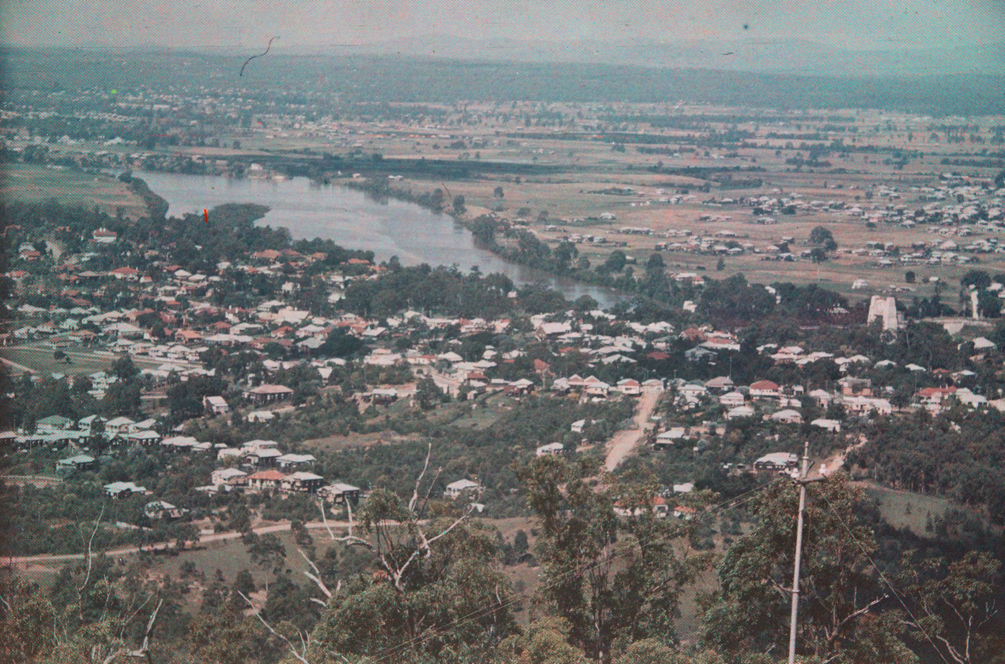 View over Indooroopilly toward Graceville from Mt. Coot-tha, c.1938. One of the two towers of the bridge house residential accommodation, which were occupied until mid 2010 can be seen on the right / 99183735298402061 / Courtesy: John Oxley Library, State Library of Queensland, Brisbane