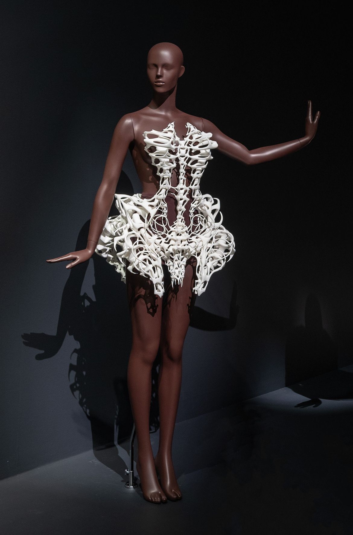 Iris van Herpen, Netherlands b.1984 / Isaïe Bloch (Collaborator), Belgium b.1986 / Materialise (Collaborator), Belgium est.1990 / Skeleton dress, from the ‘Capriole’ collection 2011 installed in ‘Iris van Herpen: Sculpting the Senses’, GOMA 2024 / 3D-printed polyamide using selective laser sintering / Worn by actor and model Milla Jovovich in Karl Lagerfeld and Carine Roitfeld, The Little Black Jacket Book: Chanel’s Classic Revisited (published by Steidl, 2012) / © & courtesy: Iris van Herpen atelier / Photograph: N Umek © QAGOMA