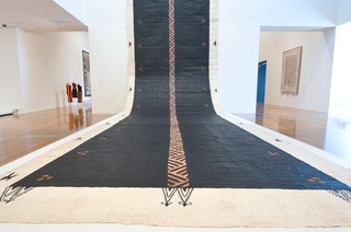 Kulupu Falehanga‘i Teleiloa, New Zealand/Tonga est. 2010 / Ngatu tā’uli 2011 / Koka (pigment from koka tree) and black commercial paint on Hiapo (paper mulberry) barkcloth / 2215 x 420cm / Commissioned 2011. QAG Foundation / Collection: Queensland Art Gallery | Gallery of Modern Art / © The artists