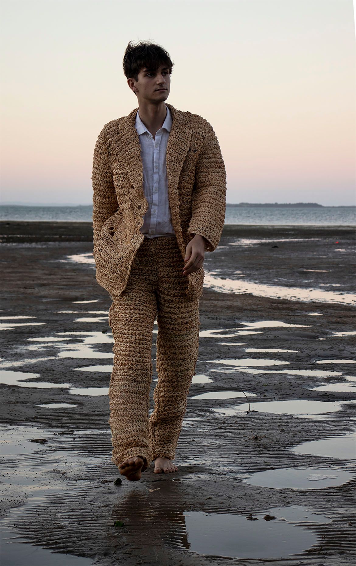 Charlotte Peachey, Redlands College, Australia b.2003 / Settler 2021 / Mixed media installation (crocheted raffia suit and digital photograph on gloss paper) / © The artist