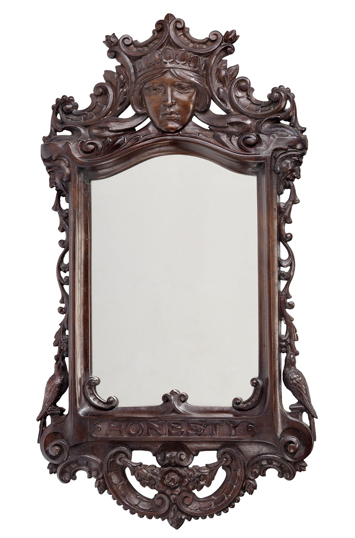L.J Harvey, Australia 1871-1949 / Honesty Mirror c.1915 / Queensland cedar, carved with allegorical representation of Thelma (crest). Also carved with birds and pendant swags on the bottom / 75.5 x 42cm / Gift of the Reverends David and Bruce Noble in memory of their mother Elsie Harvey Noble through the Queensland Art Gallery Foundation 2008 / Collection: Queensland Art Gallery | Gallery of Modern Art