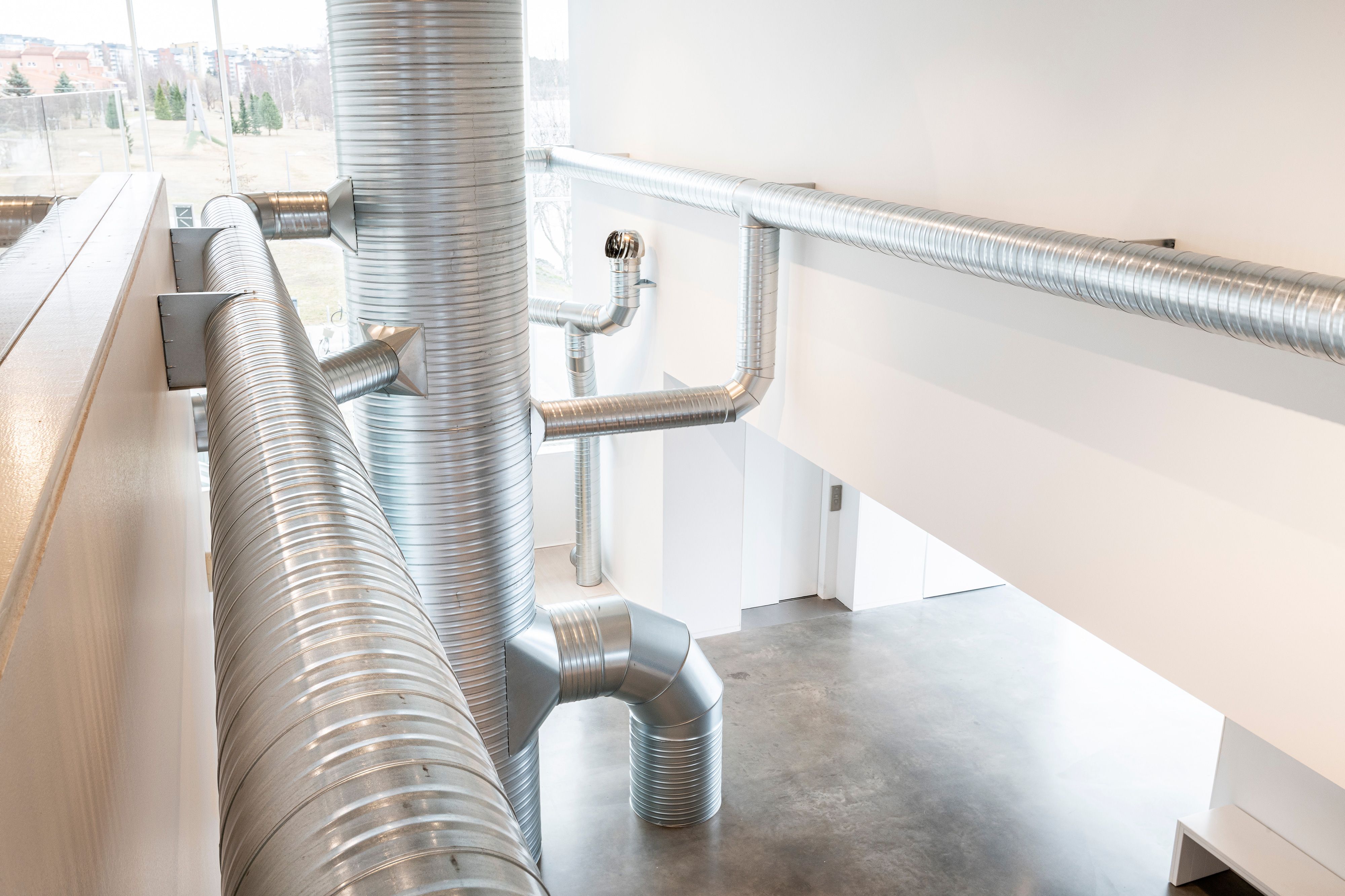 Nancy Holt / United States 1938–2014 / Ventilation System 1985–92 / Installation view, Bildmuseet, Umeå, Sweden, 2022 / Steel ducts, turbine ventilators, shanty caps, fans, air [materials are locally sourced with each presentation] / Overall dimensions variable [site responsive] / Collection: Holt/Smithson Foundation / Photograph: Mikael Lundgren or Polly Yassin [TBC] / © Holt/Smithson Foundation, Licensed by VAGA at ARS, New York