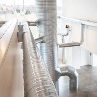 Nancy Holt / United States 1938–2014 / Ventilation System 1985–92 / Installation view, Bildmuseet, Umeå, Sweden, 2022 / Steel ducts, turbine ventilators, shanty caps, fans, air [materials are locally sourced with each presentation] / Overall dimensions variable [site responsive] / Collection: Holt/Smithson Foundation / Photograph: Mikael Lundgren or Polly Yassin [TBC] / © Holt/Smithson Foundation, Licensed by VAGA at ARS, New York