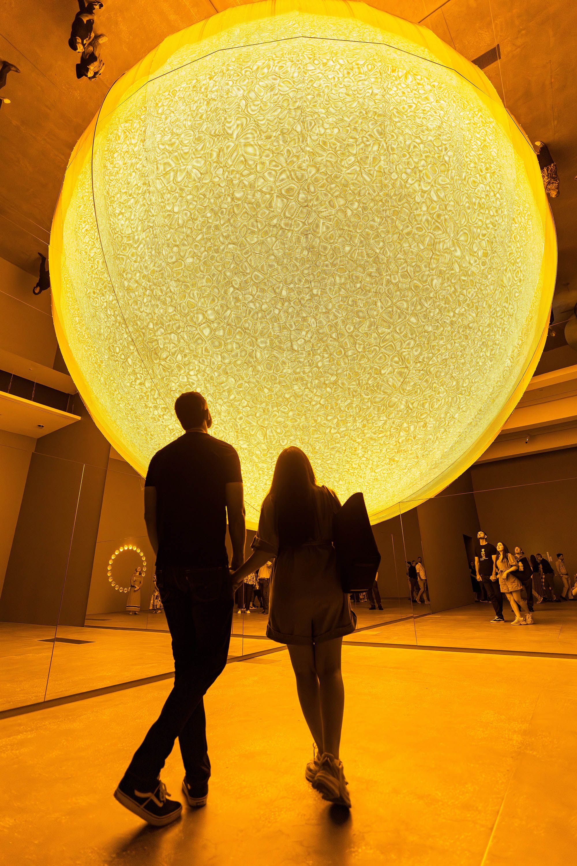 Olafur Eliasson, Denmark b.1967 / Presence 2025 / Stainless steel, aluminium, monofrequency lights, printed textile wedges, aluminium perforated sheets, mirror foil, glass mirror, wood / © 2025 Olafur Eliasson / Courtesy: The artist; neugerriemschneider, Berlin; and Tanya Bonakdar Gallery, New York / Los Angeles / Photograph: K Bennett © QAGOMA