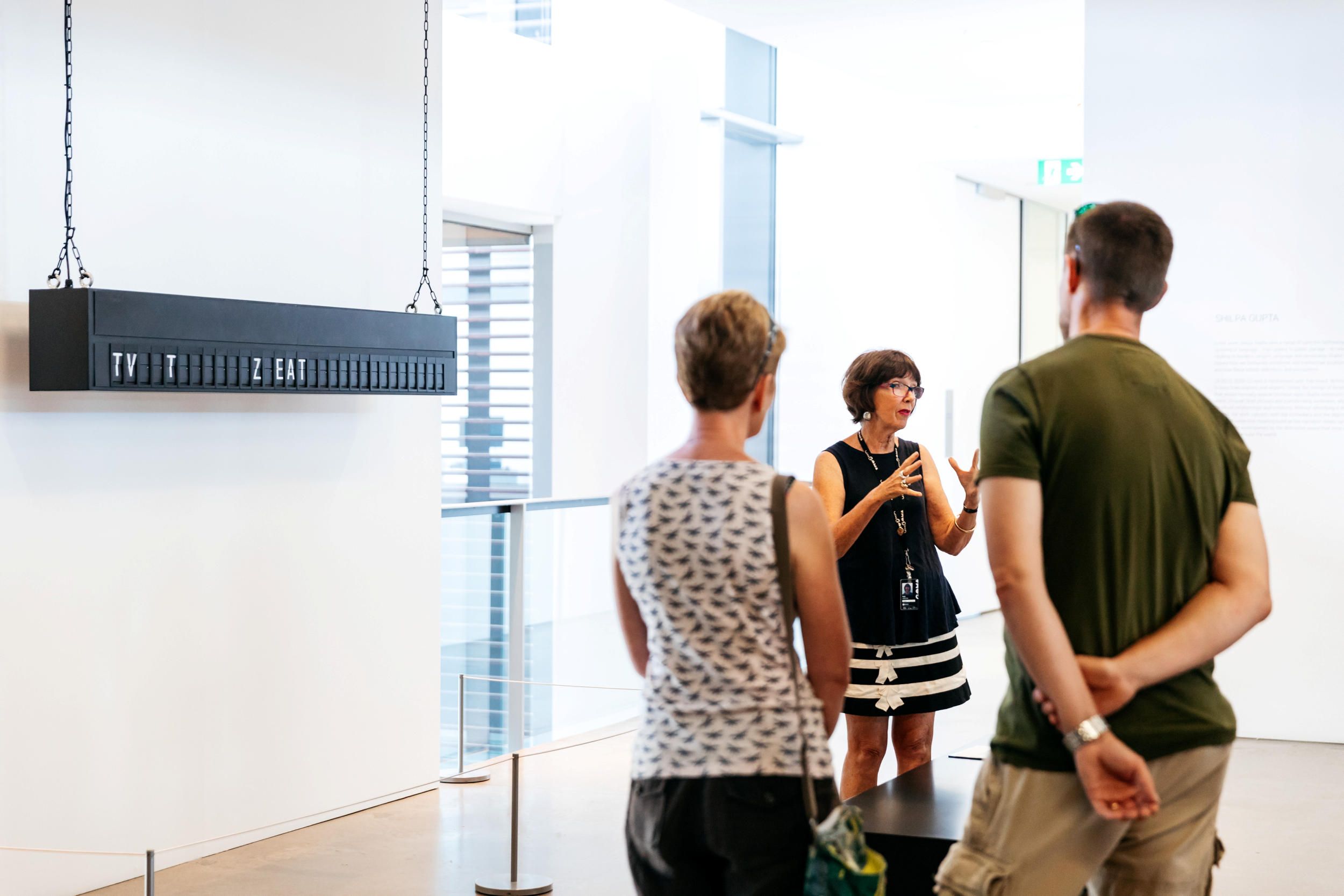 A Volunteer Guide engages visitors on a tour at the Gallery Modern Art. Photography by Joe Ruckli | QAGOMA