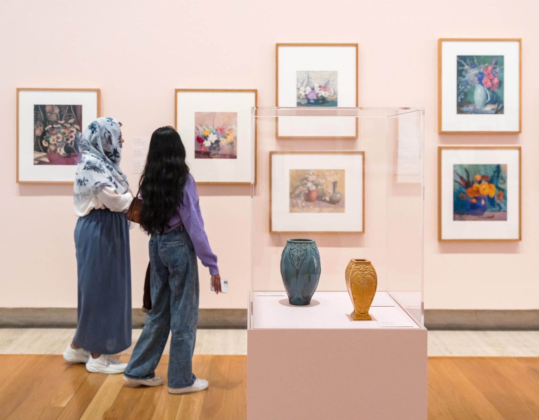 Visitors to 'Under a Modern Sun' view works by Vida Lahey, including Blue-eyed daisies 1959 / Bequest of George Brown 1977 / Photograph: K Bennett