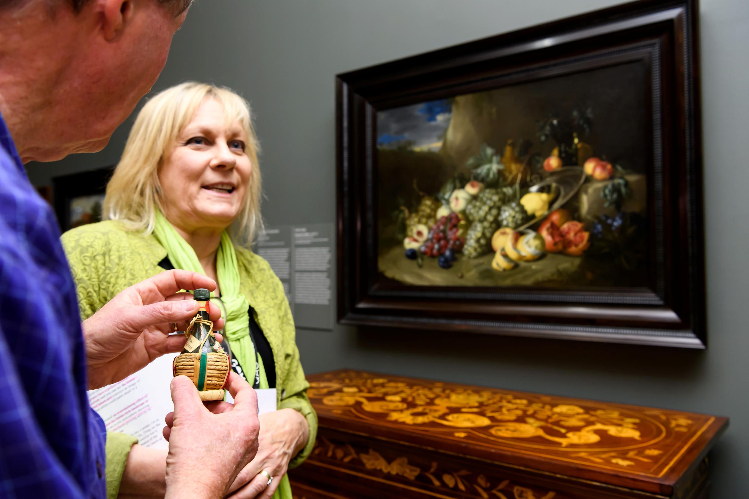 Visitor exploring a still life object as part of a tactile experience, featuring Alexander Coosemans Still Life c.1650, September 2018, QAG / Photograph: C Callistemon © QAGOMA