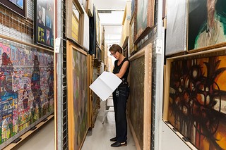 Collection Relocation and Mezzanine project 2016-17 Collection preparation in Collection Storage Conservator Anne Carter assessing painting for handling and moving requirements On left: BRYANT, Charles Concarneau c.1914-20 Acc. 1:0925