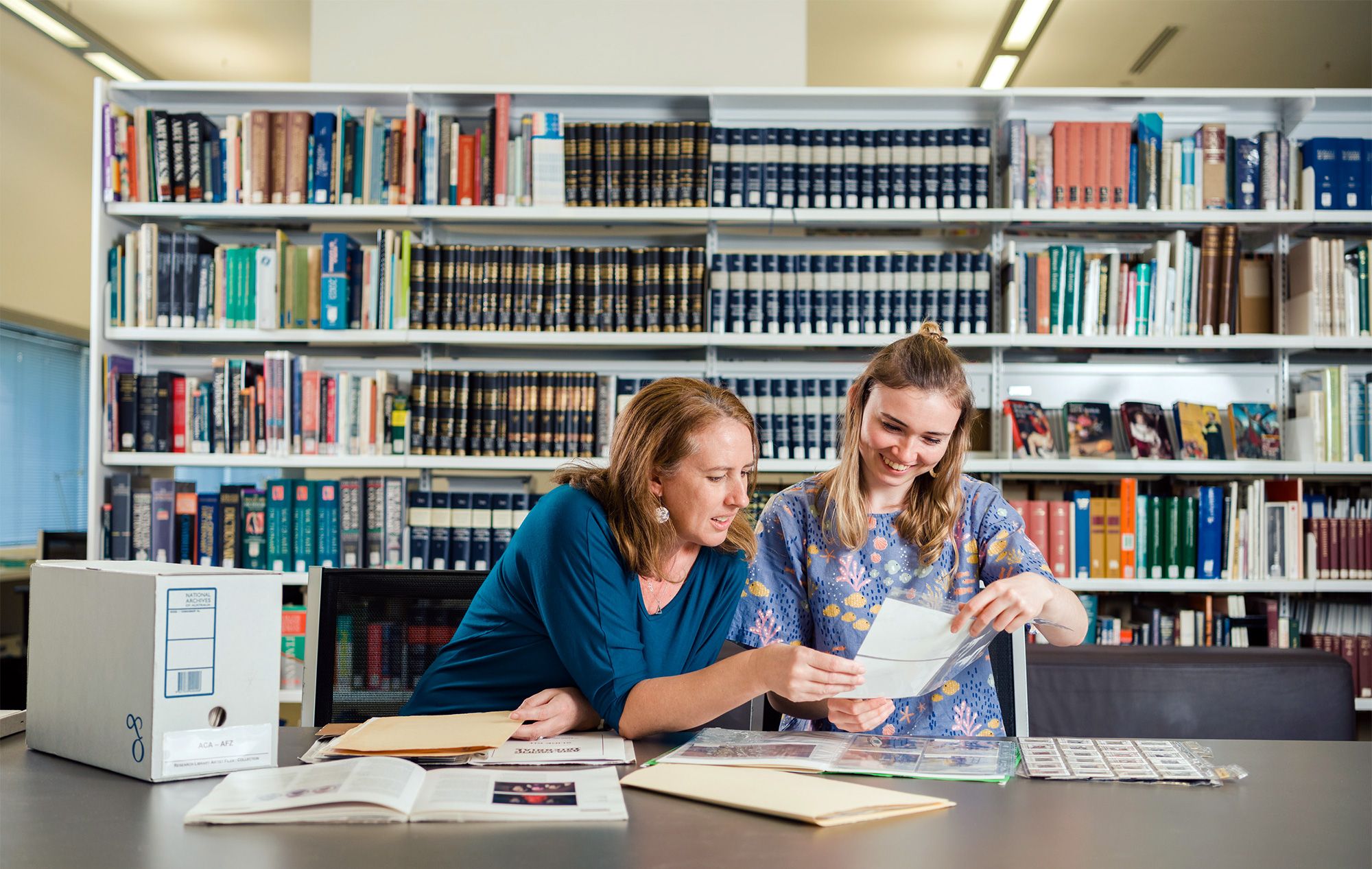 Gallery staff searching the QAGOMA Research Library files for information / Photograph: J Ruckli © QAGOMA