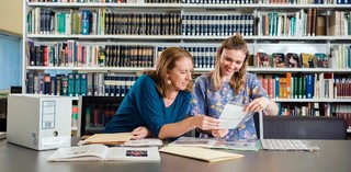 Gallery staff searching the QAGOMA Research Library files for information / Photograph: J Ruckli © QAGOMA