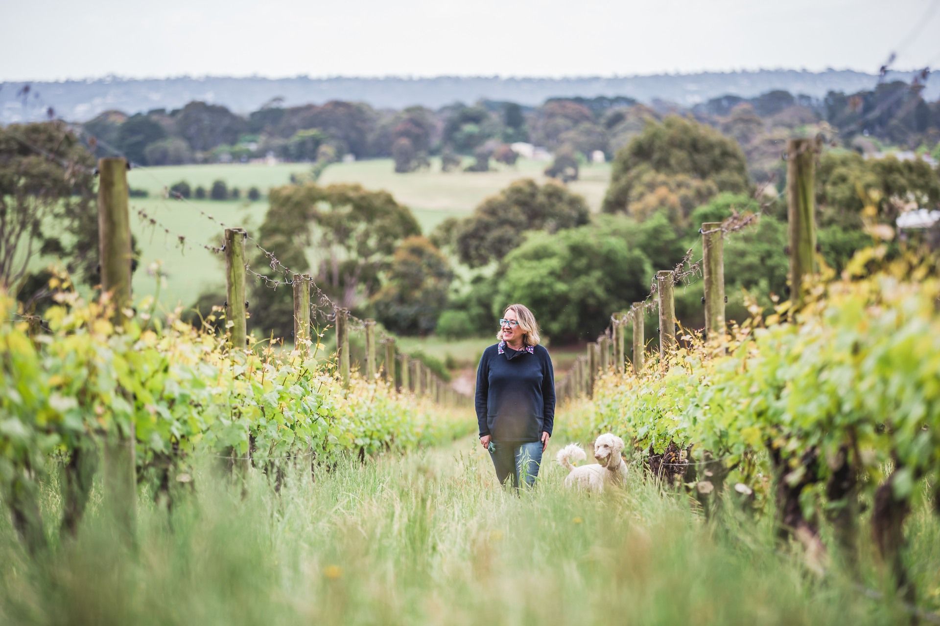 Kate McIntyre, Master of Wine, in the McIntyre Vineyard with Polly