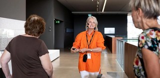 Visitors with hearing loss use assistive listening devices during a volunteer guided tour at the Gallery of Modern Art. Photograph: C. Callistemon