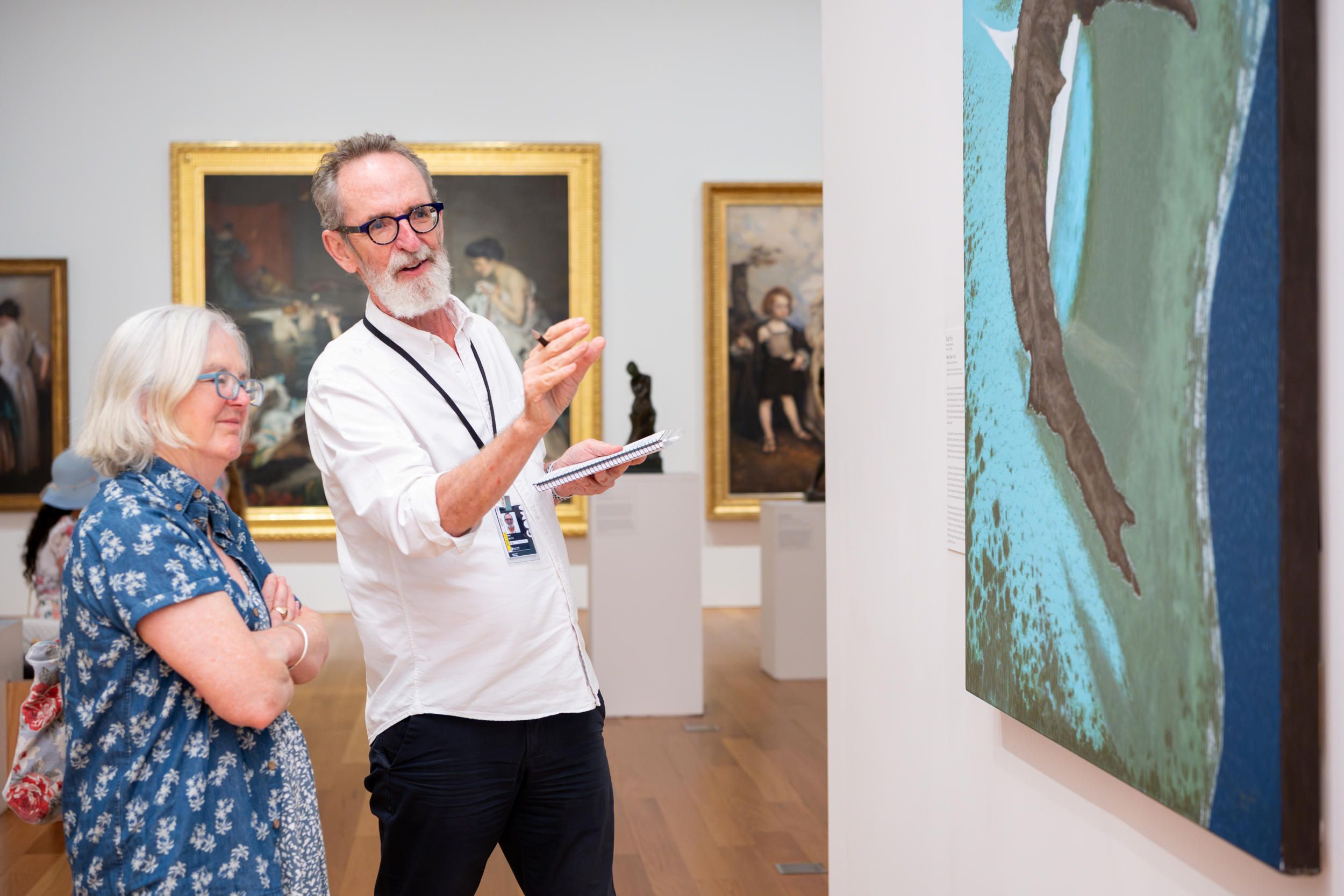 A Volunteer Guide engages visitors on a tour at the Queensland Art Gallery. Photography by Chloe Callistemon | QAGOMA