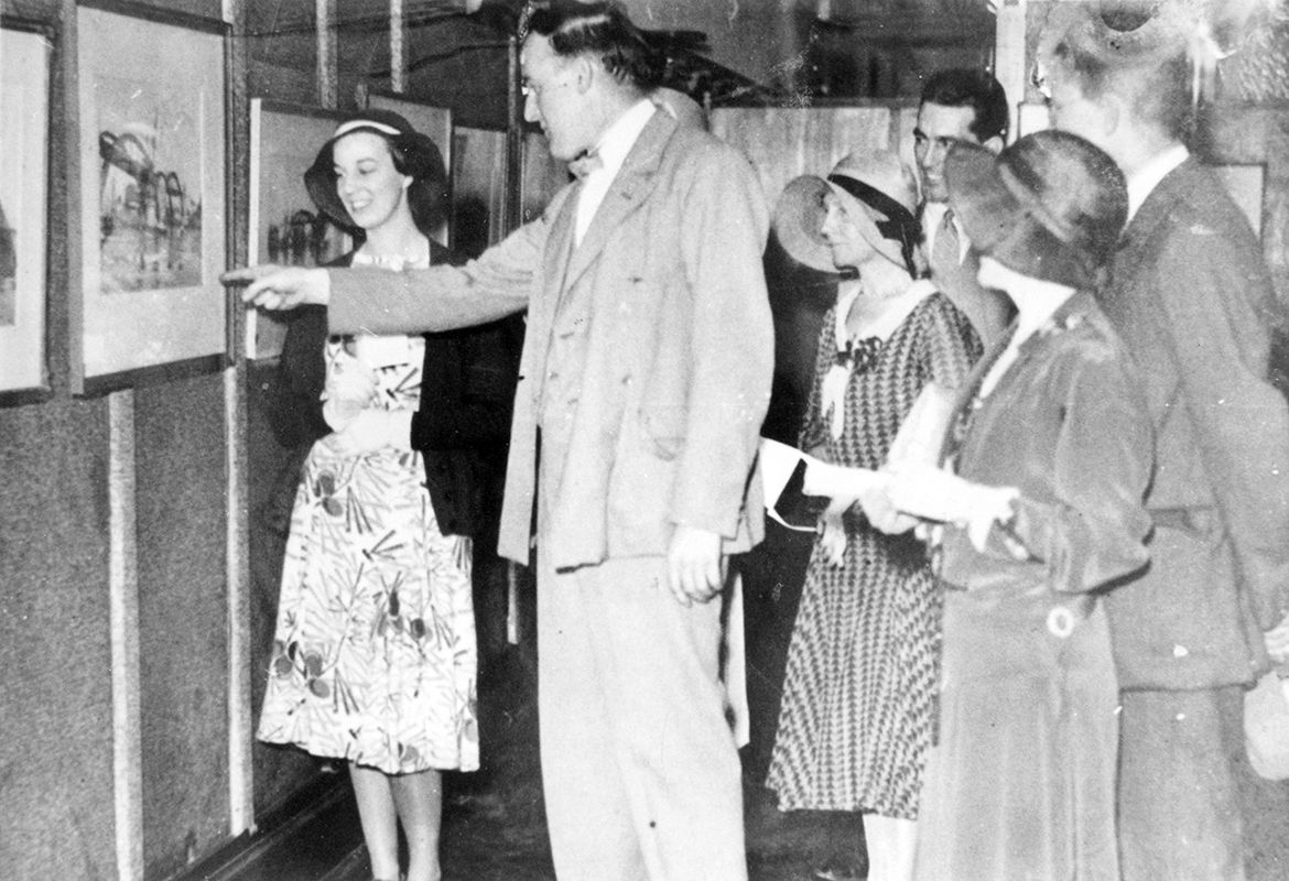 William Bustard at his first solo exhibition at the Griffith Brothers Tea Rooms in Brisbane, October 1931 / 9183725938902061 / Courtesy: John Oxley Library, State Library of Queensland, Brisbane