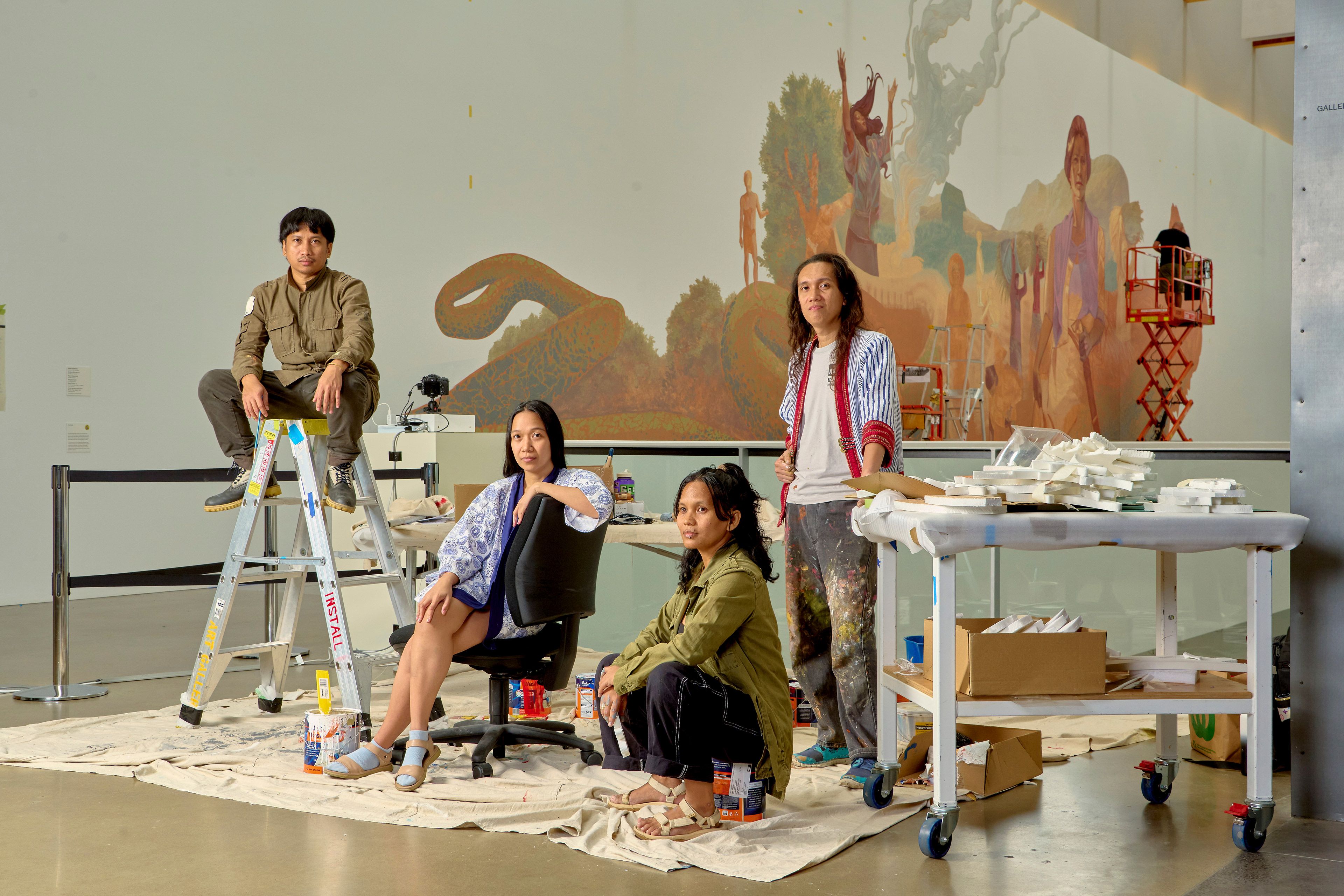 Kikik Kollektive (est. 2017, Iloilo, the Philippines) during the installation of their mural Tul-an sang aton kamal-aman (Bones of our elders) 2024, GOMA, October 2024 / Commissioned for APT11 / © Kikik Kollective / Photograph: J Ruckli, QAGOMA