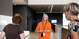 Visitors with hearing loss use assistive listening devices during a volunteer guided tour at the Gallery of Modern Art. Photograph: C. Callistemon
