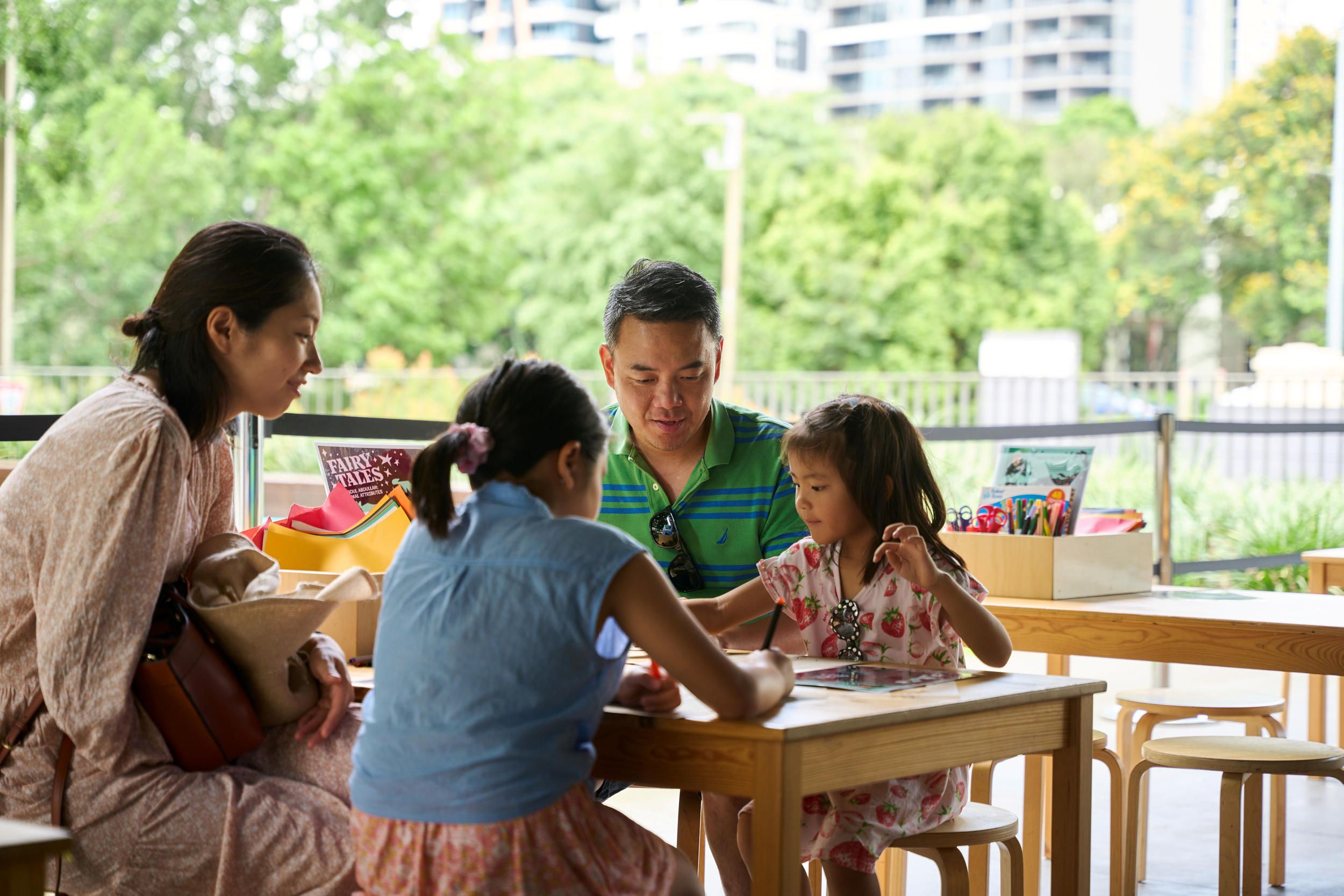 A family participating in a workshop at the Bodhi Tree Terrace, 2024 / Photograph: C Sanders / ©QAGOMA