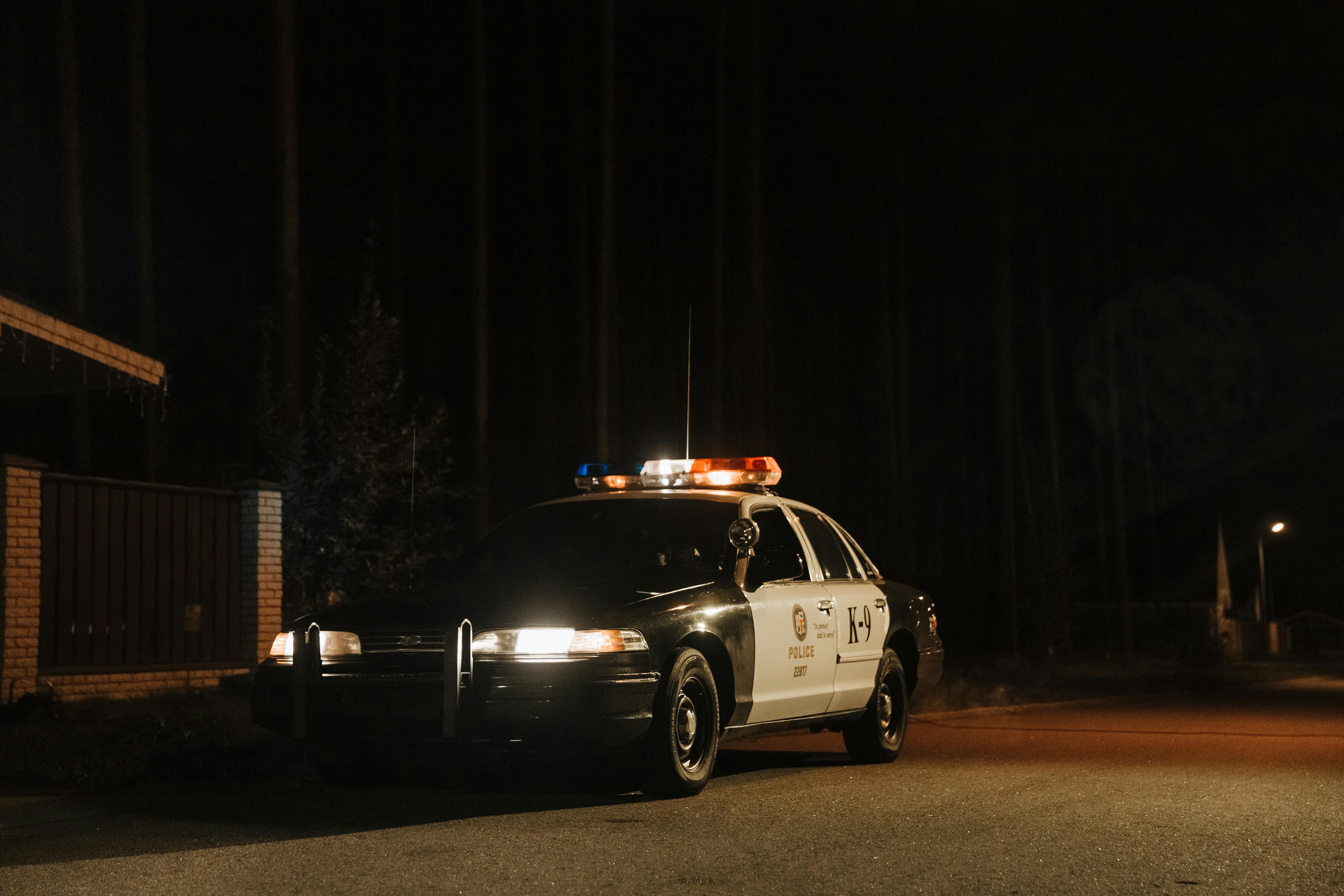 Police car with flashing lights during a nighttime DUI stop after drinking near Disneyland.