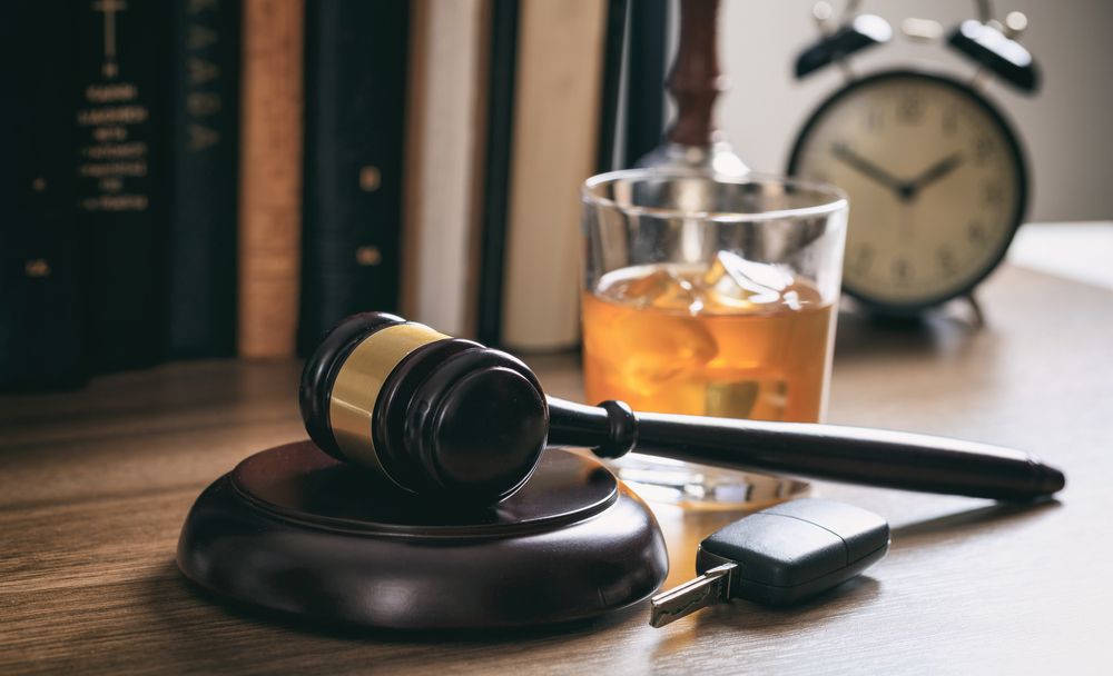 Judge gavel, car keys, and whiskey glass representing a DUI hearing case in Los Angeles court