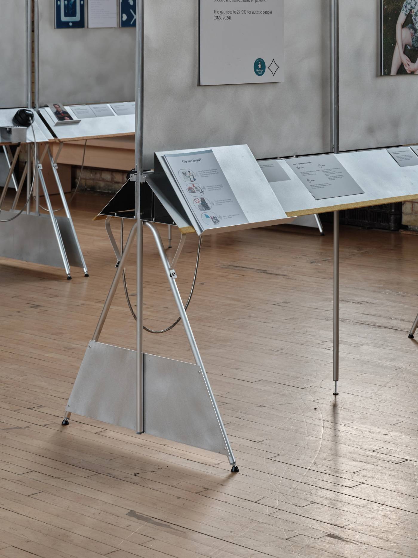 A photograph of a detail of an aluminium showcase design with triangular supports.