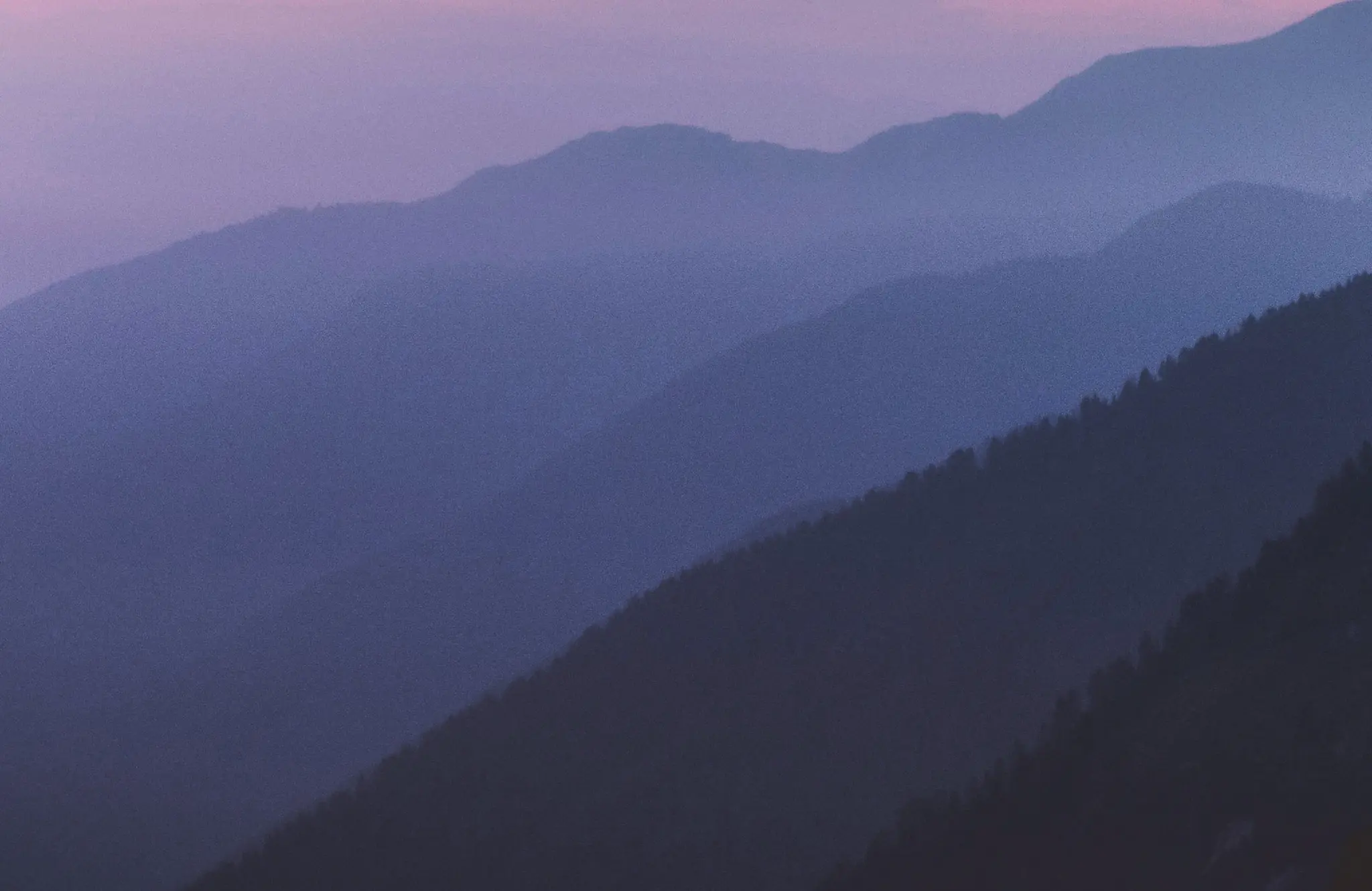 A preview image of a hazy mountain range at dusk