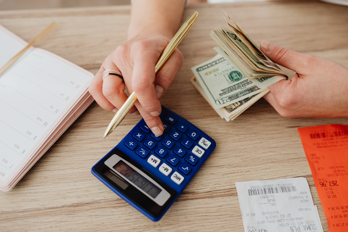 Person with calculator and banknotes