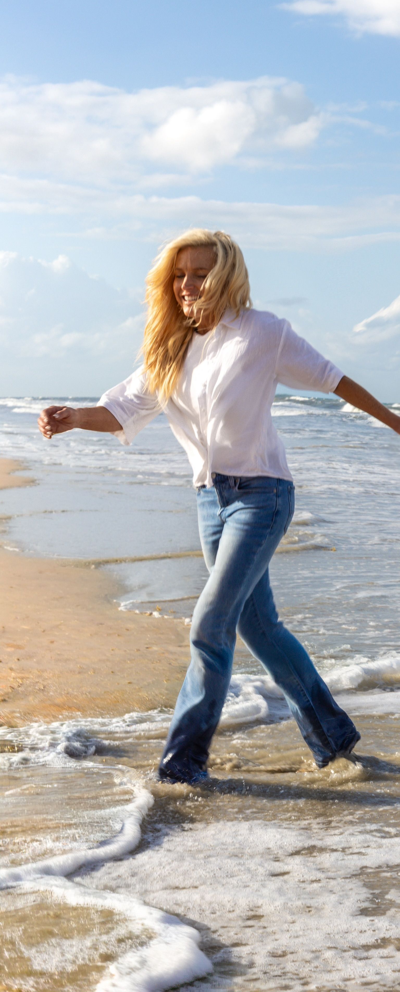 Sherry smiling while walking at the beach