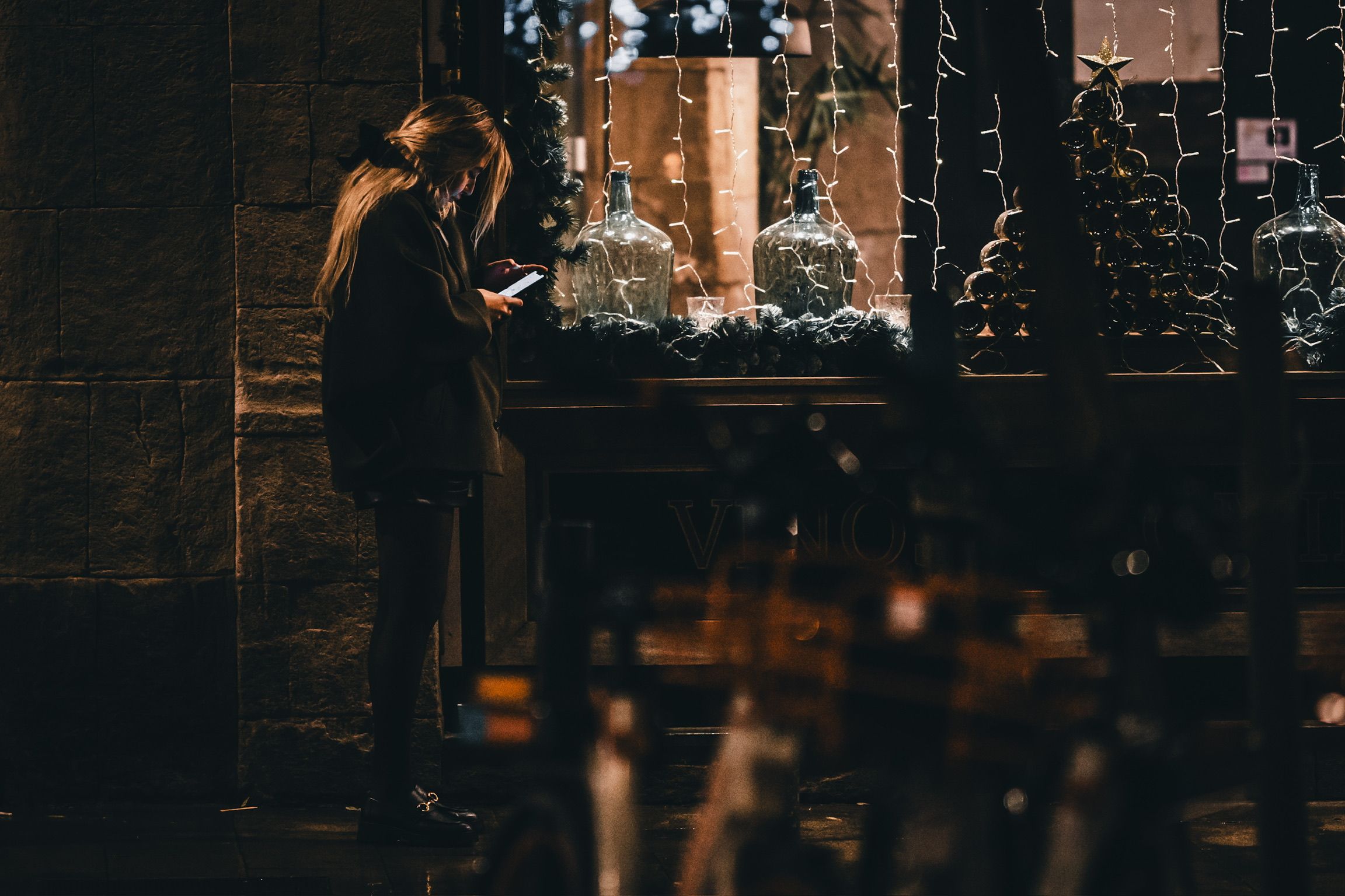 Person watching their phone under the lights.