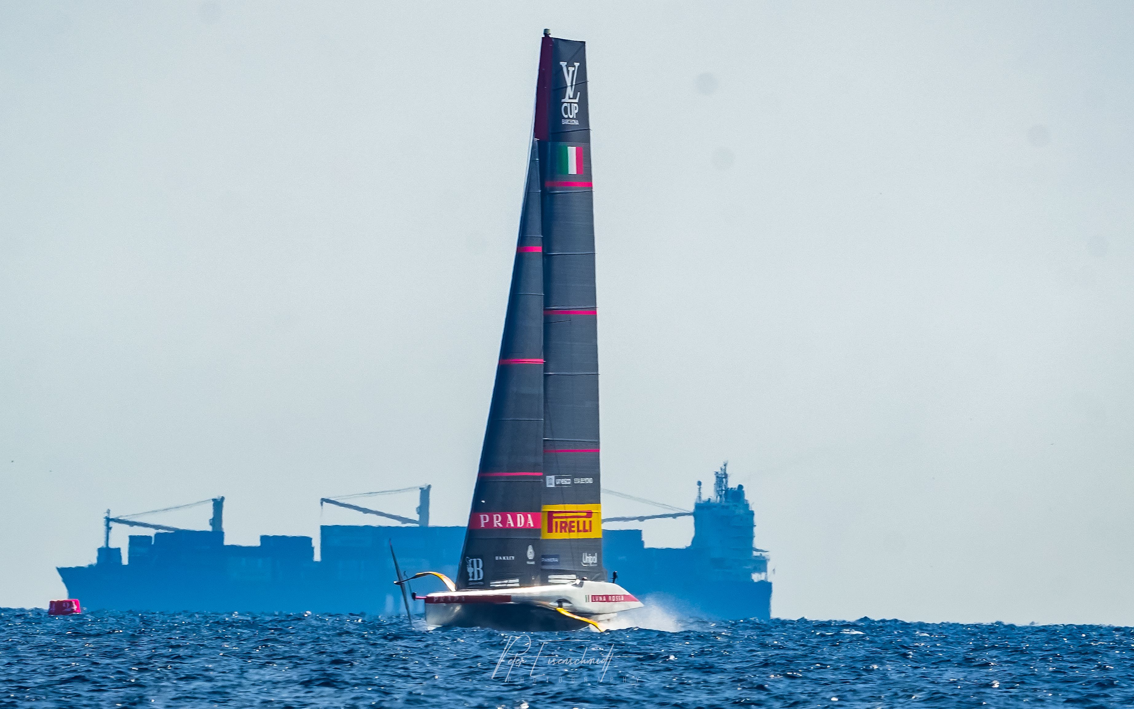 America’s Cup Prada in front of big vessel 