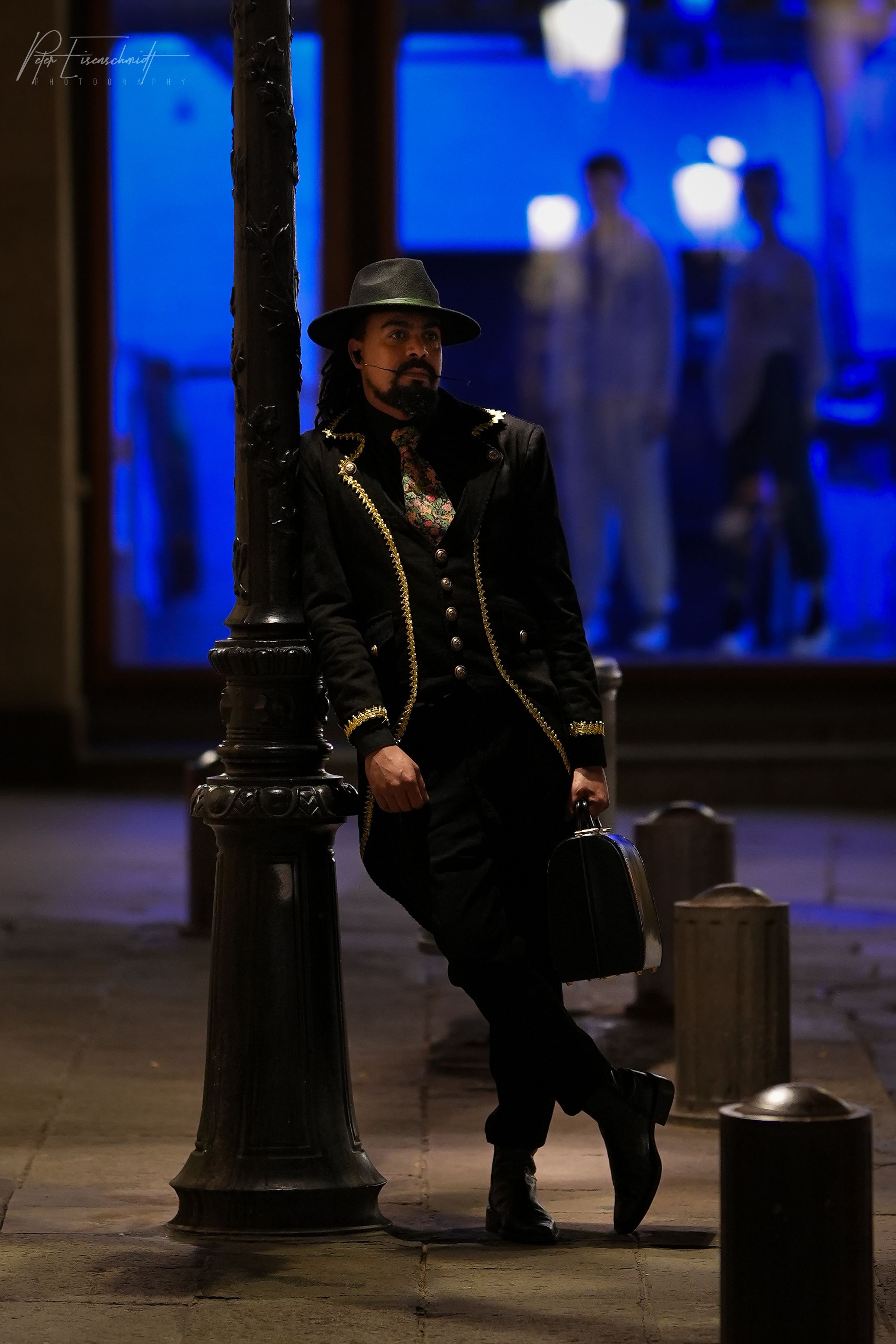 Man leaning on lamppost 