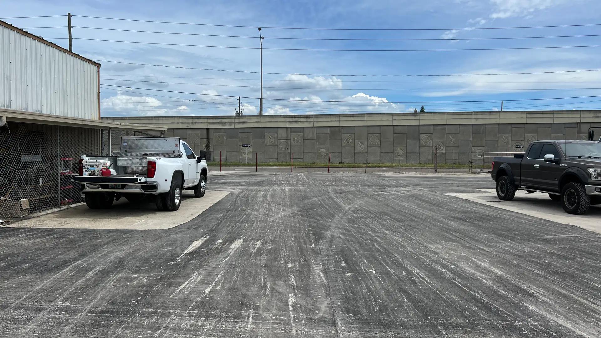 Milled pavement surface across an industrial parking area