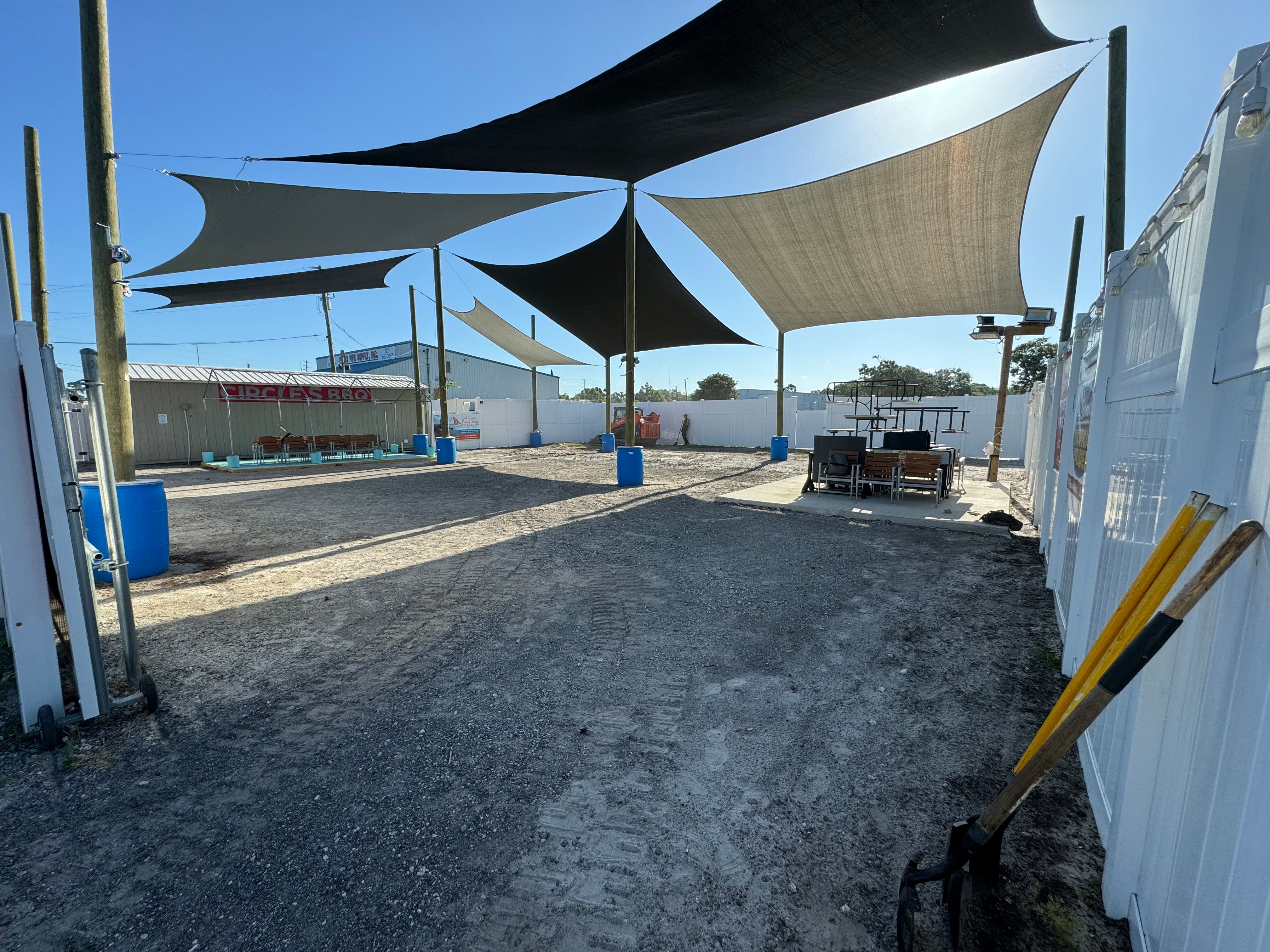 Fresh asphalt surface beneath a covered commercial structure