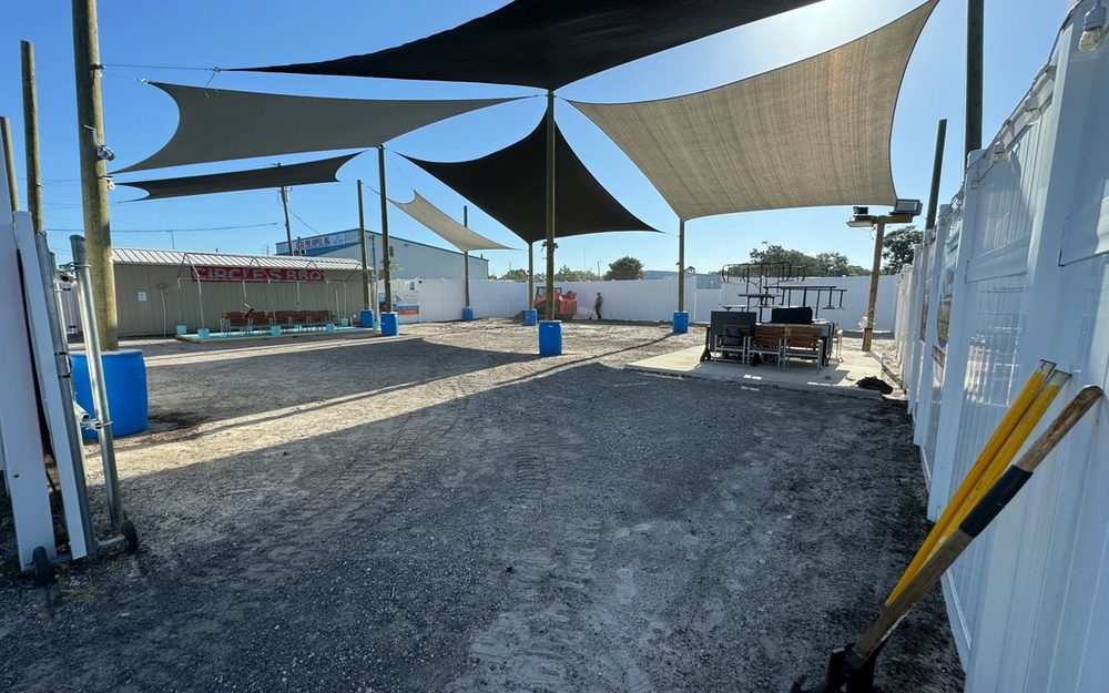 Fresh asphalt surface beneath a covered commercial structure