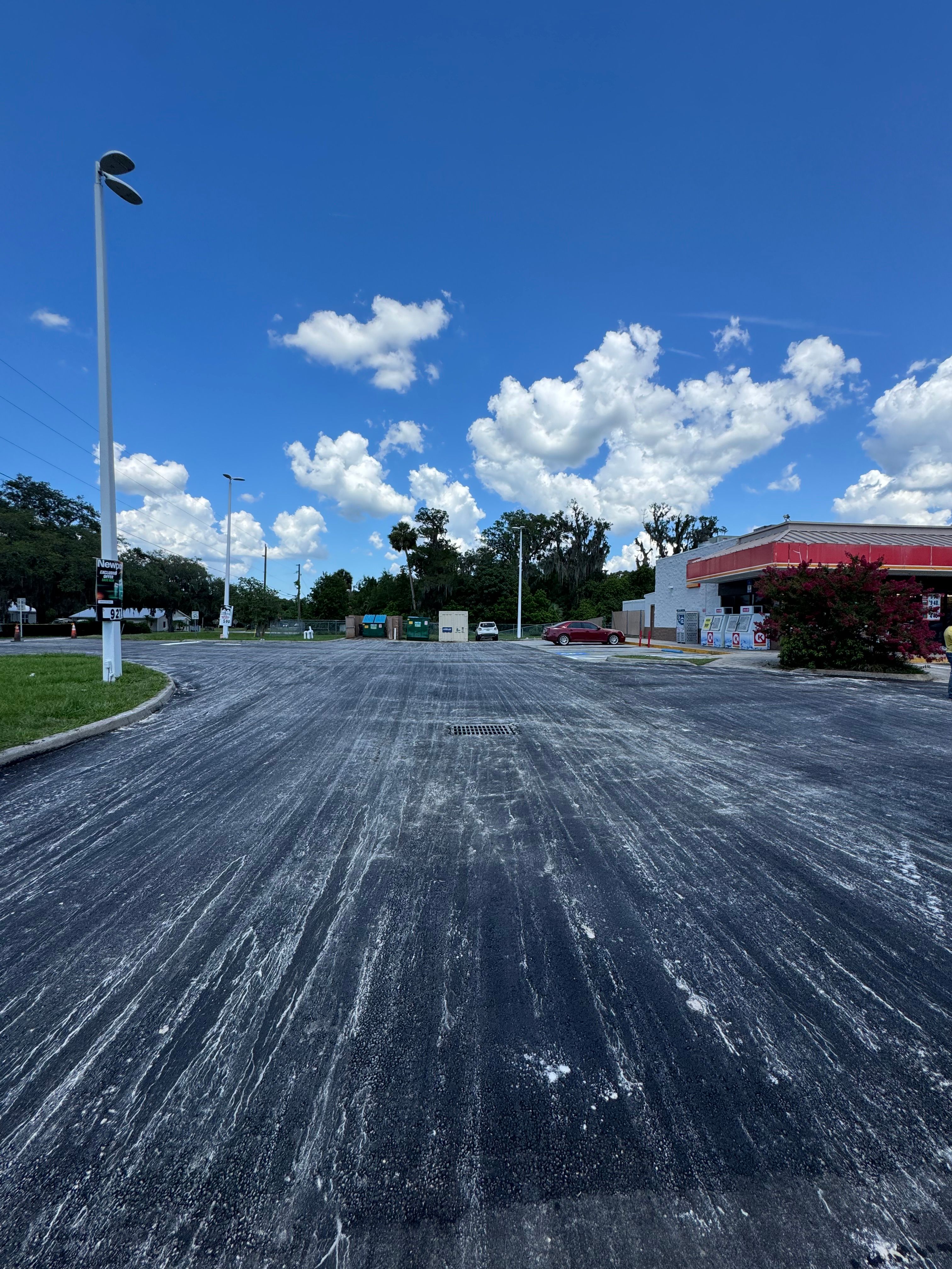 Completed asphalt surface across a convenience-store lot