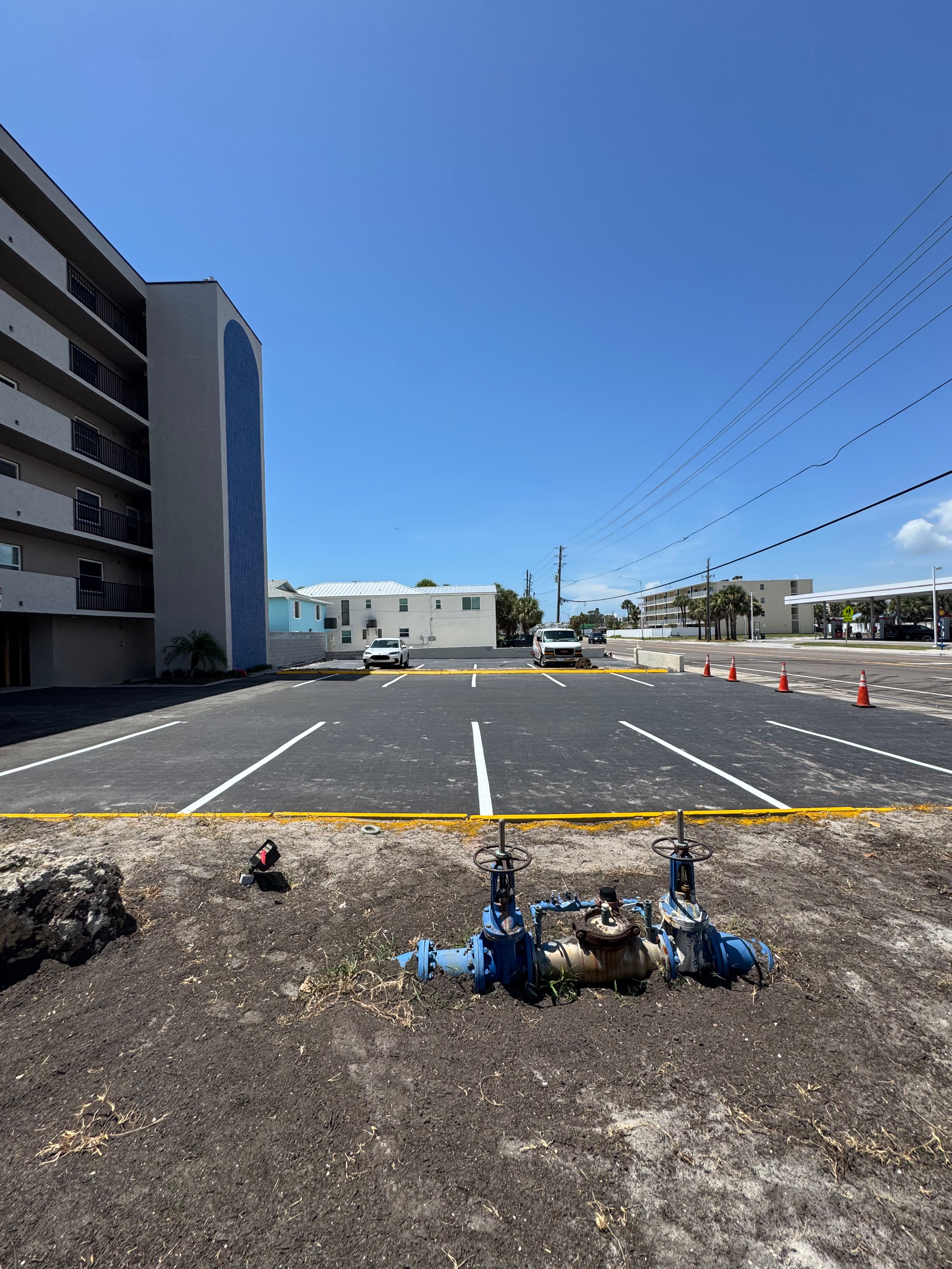Fresh parking-space and curb markings beside a commercial building