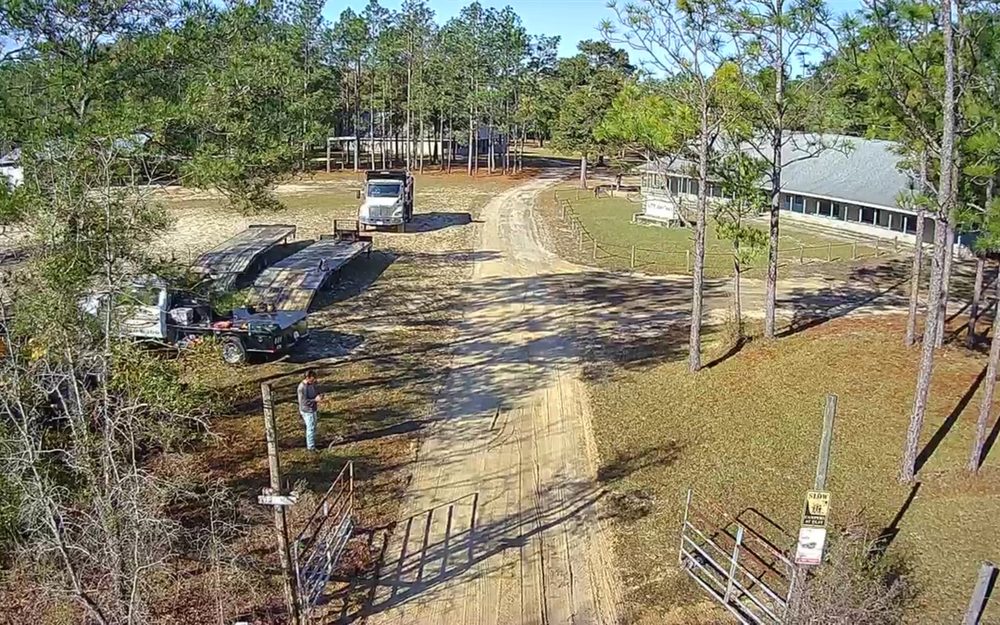 Aerial view of a long private driveway before paving