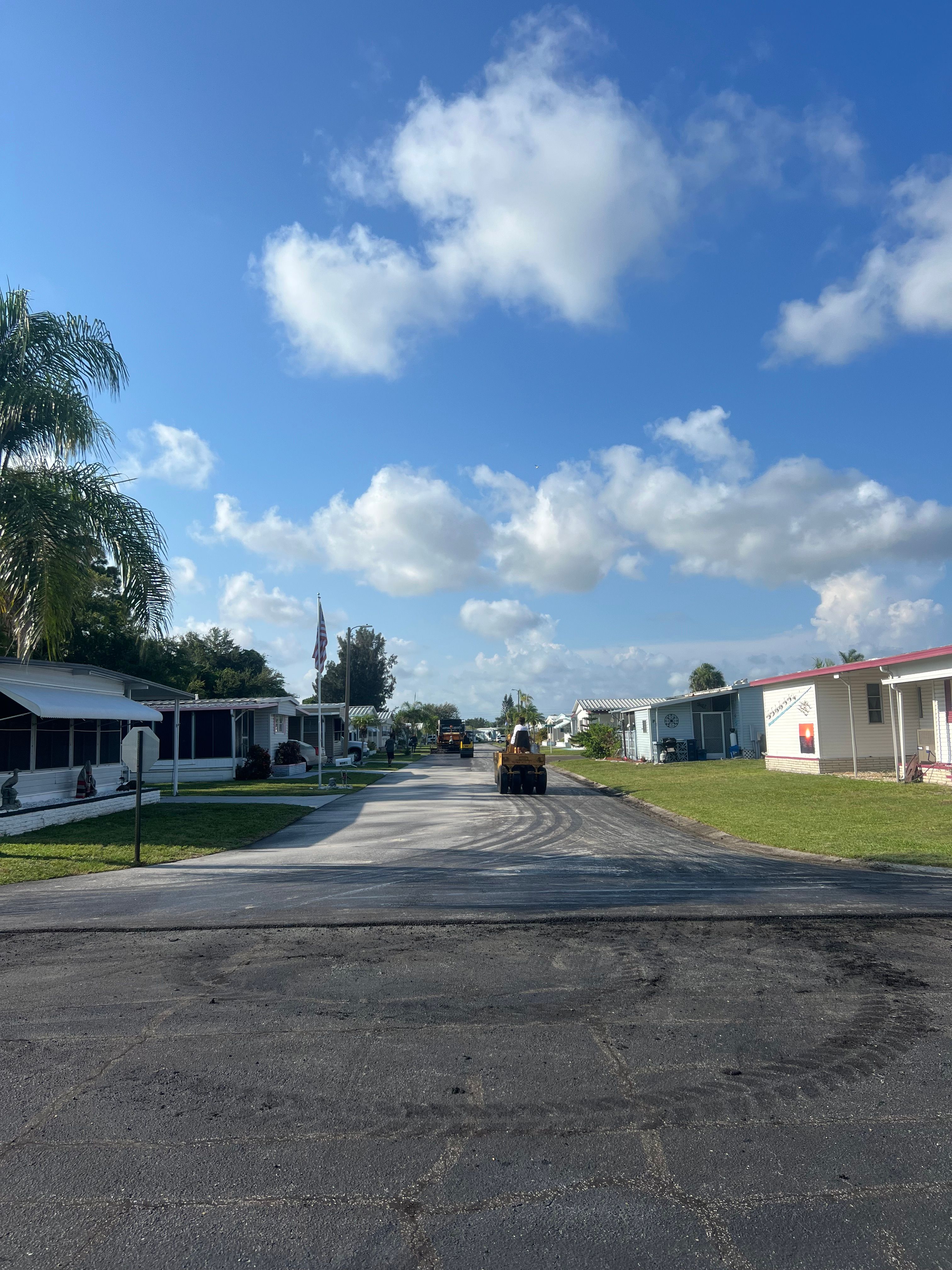 Newly paved asphalt street through a residential community