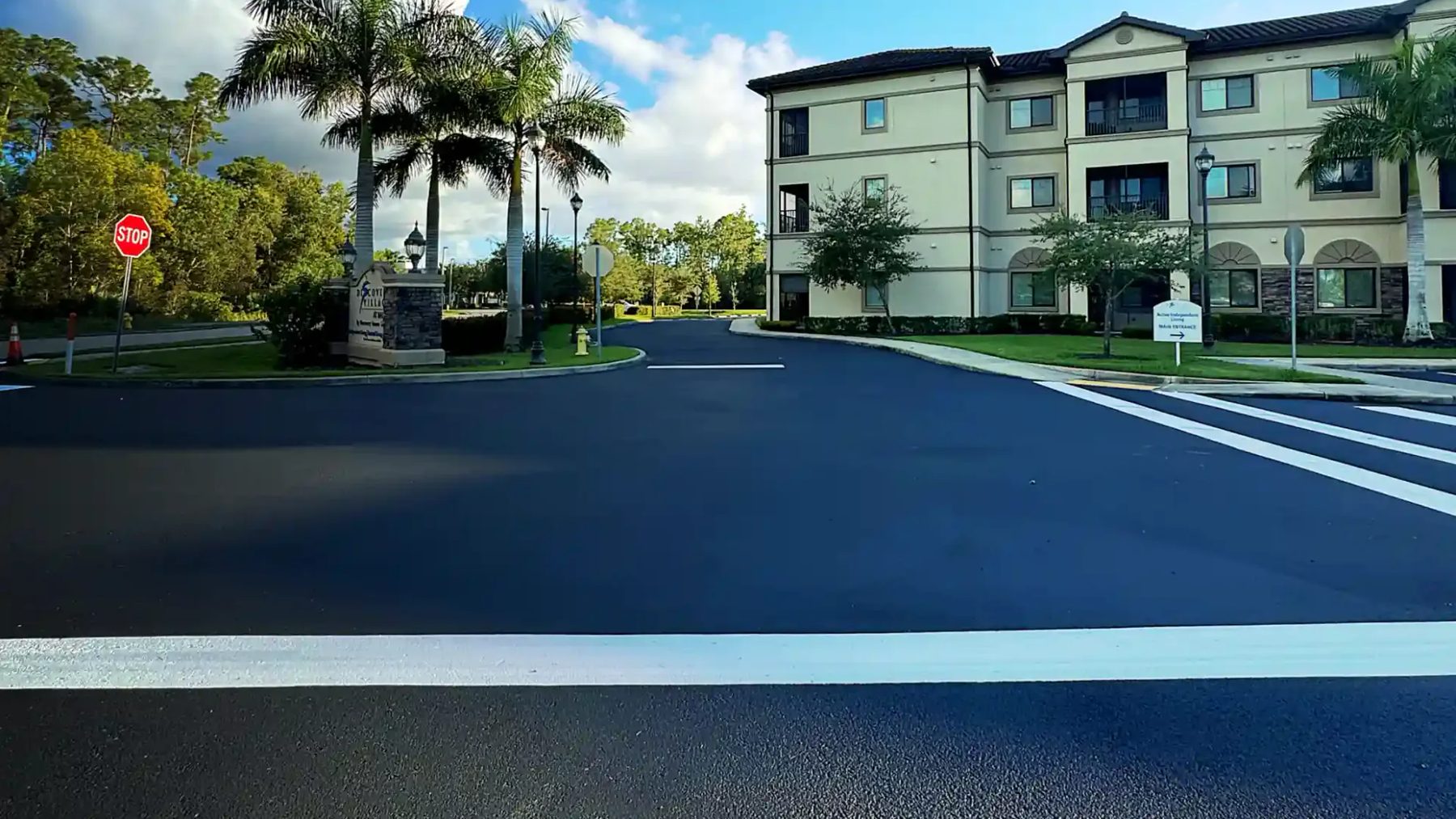 Dark sealcoated commercial roadway with crisp white traffic markings