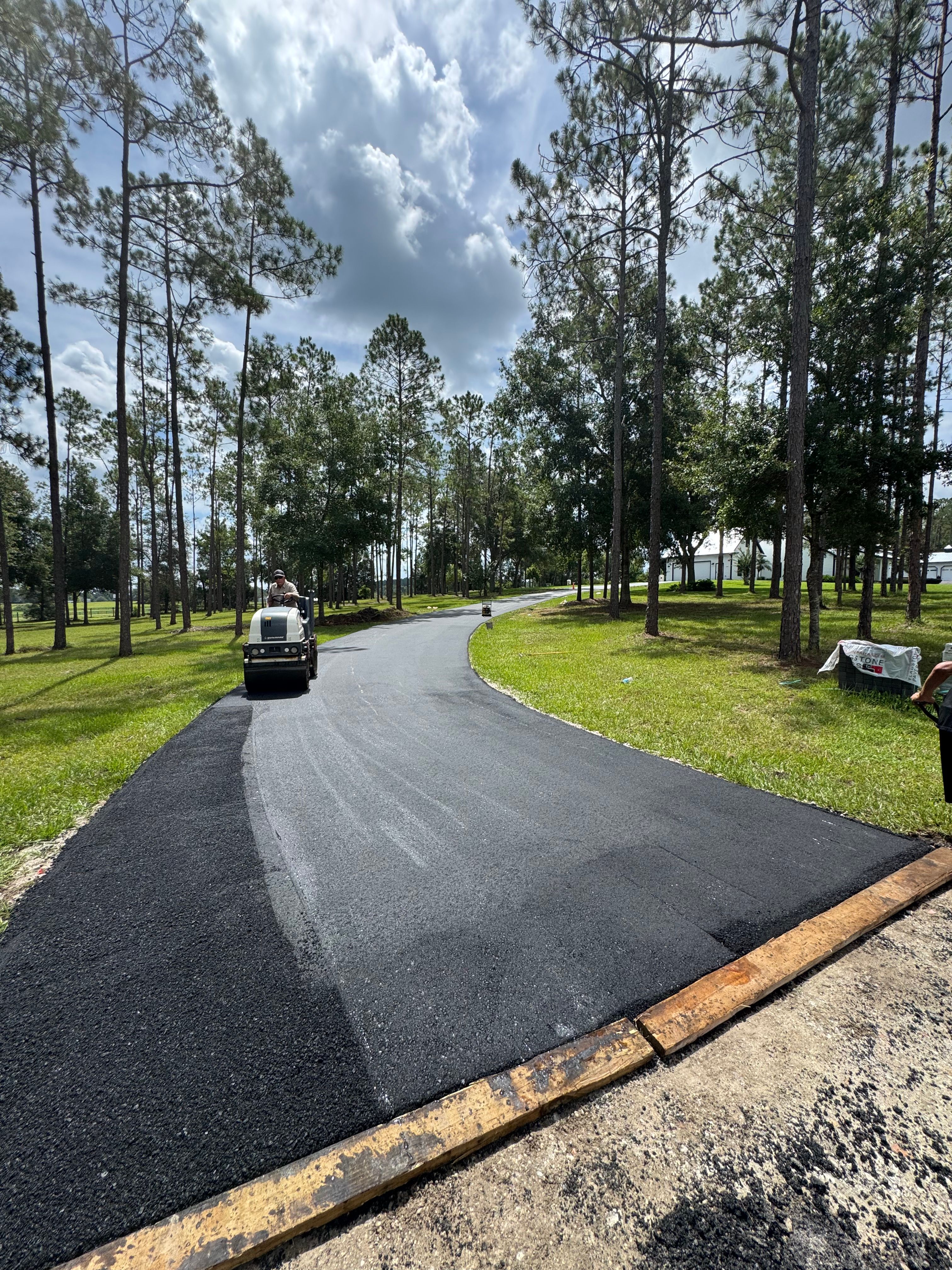 New asphalt surface along a tree-lined private road