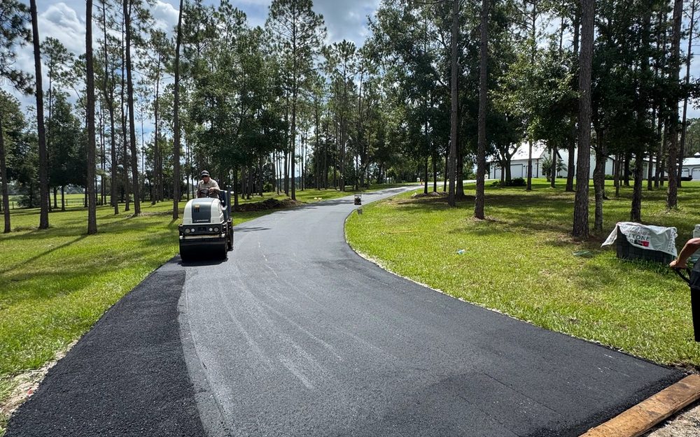 New asphalt surface along a tree-lined private road