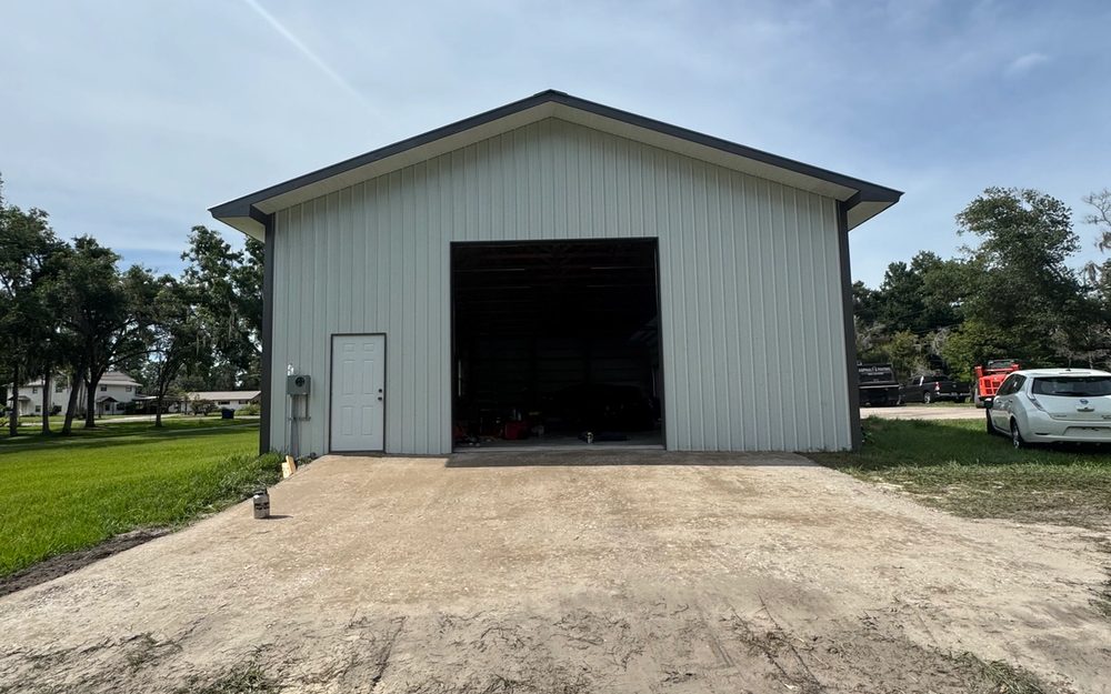 Unpaved driveway and apron before asphalt work at an outbuilding