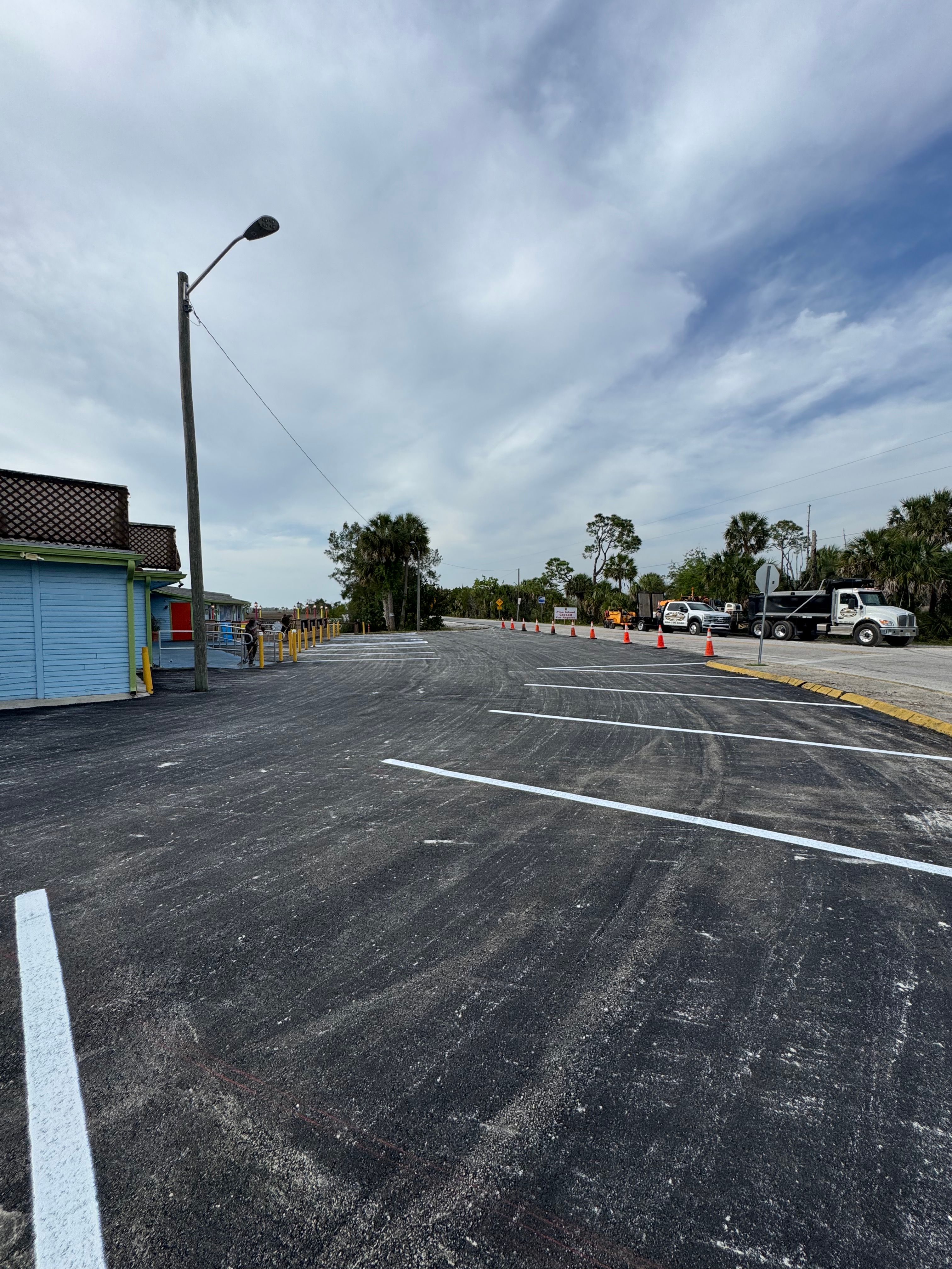 Fresh parking-space markings on a resurfaced commercial lot