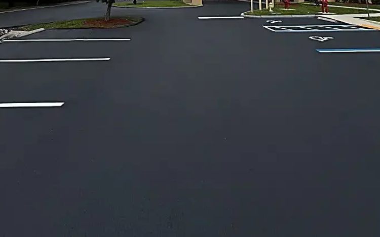 Commercial parking lot with dark sealcoat and fresh white parking-space markings