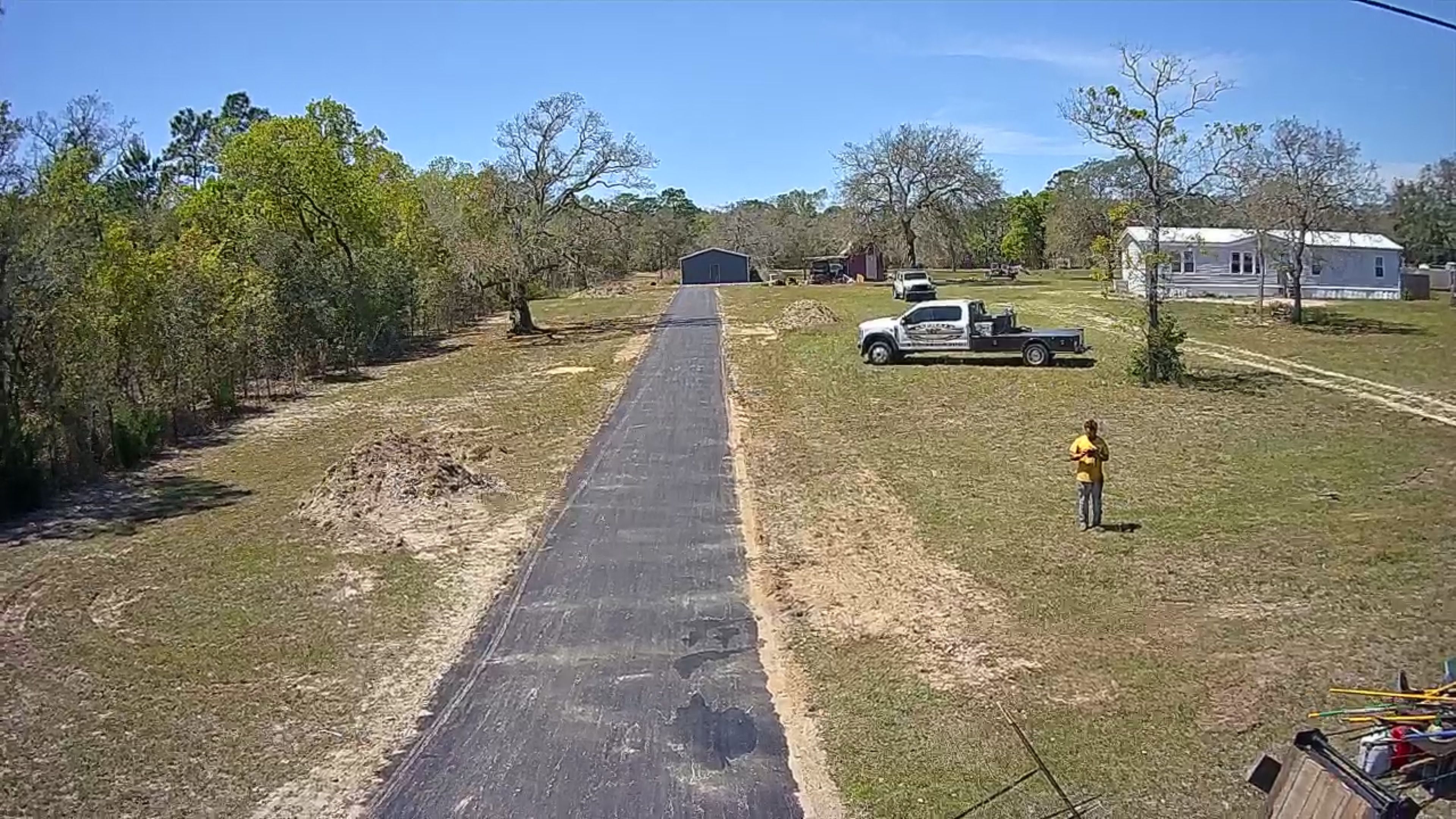 Long completed asphalt driveway viewed from above